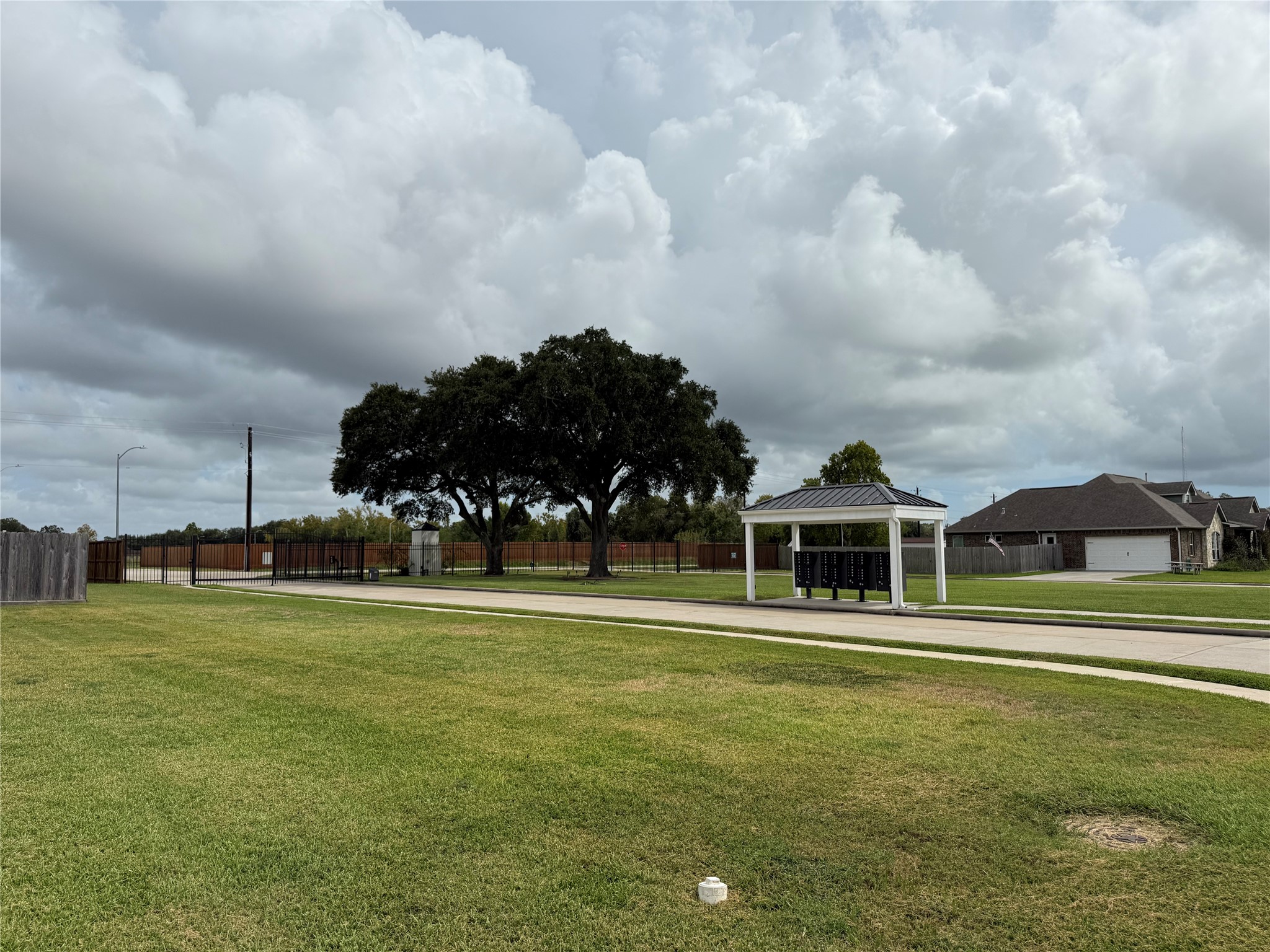 Community gate and mailboxes, located to the right of the lots when facing them from E Tower Cir. Community gate and mailboxes, located to the right of the lots when facing them from E Tower Cir.
