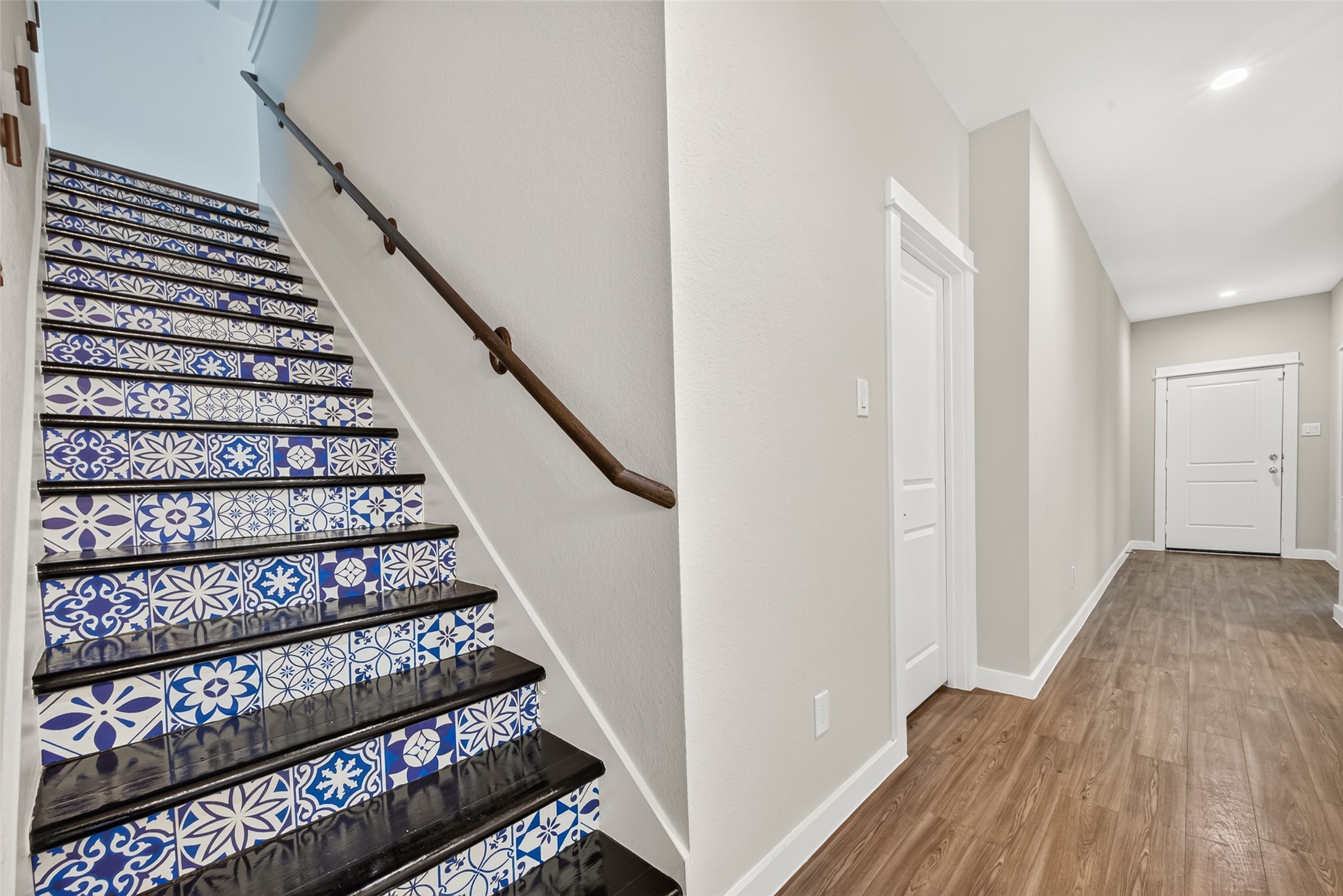 Decorative patterned stair risers add a distinctive touch along the staircase leading to the upstairs living spaces.