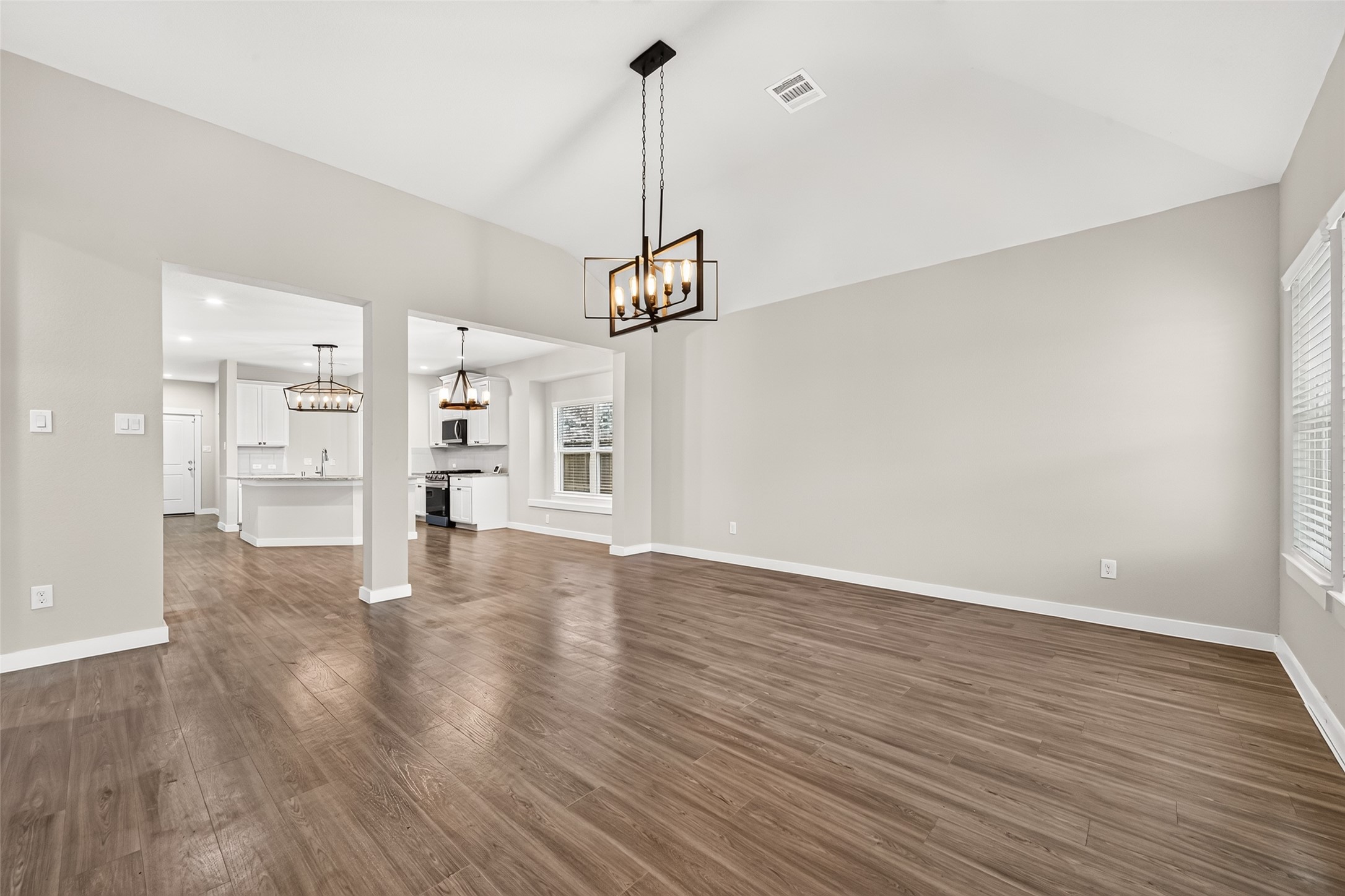 The spacious family room connects to the dining area and kitchen, creating an inviting layout for everyday living and entertaining.