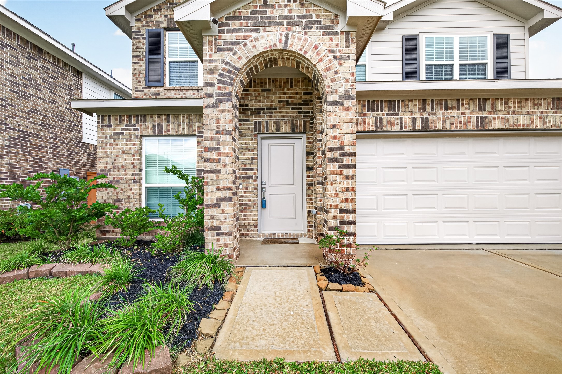The entry hallway welcomes you with neutral finishes, wood-look flooring, and convenient access to the study.