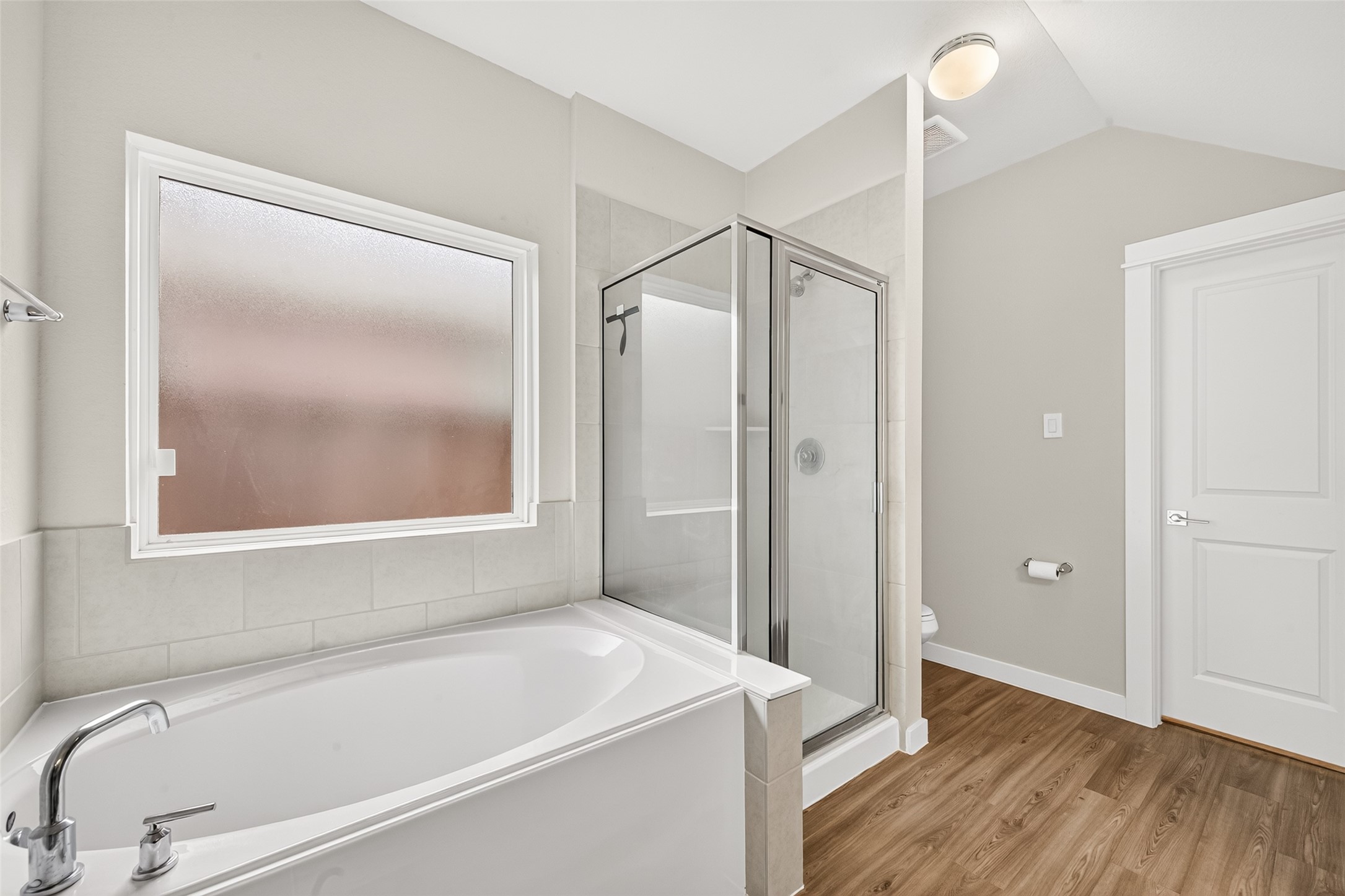 A separate soaking tub and glass-enclosed shower give the primary bathroom flexible options for your daily routine.