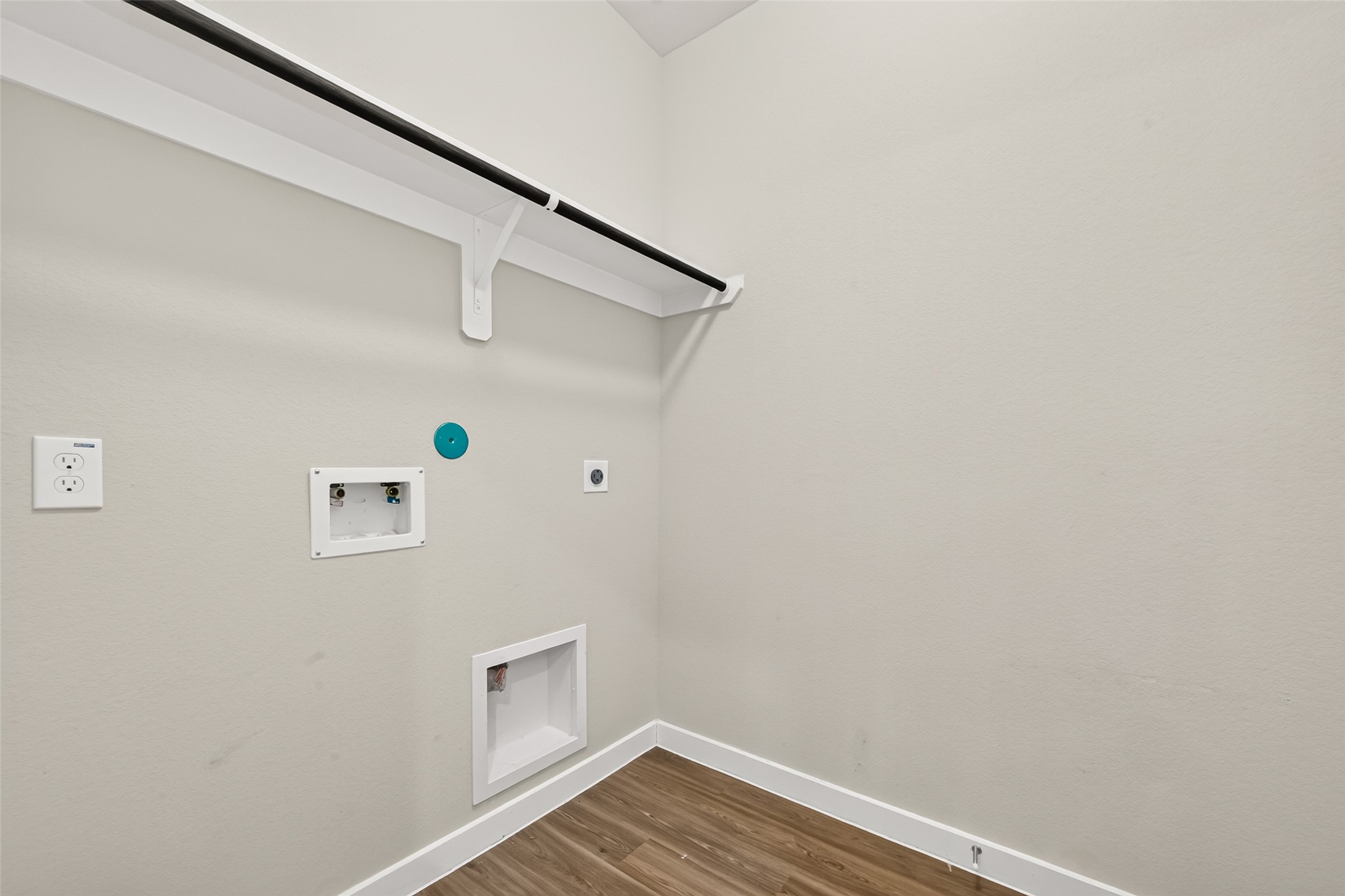 The utility room includes washer and dryer connections, an overhead shelf, and a hanging rod.