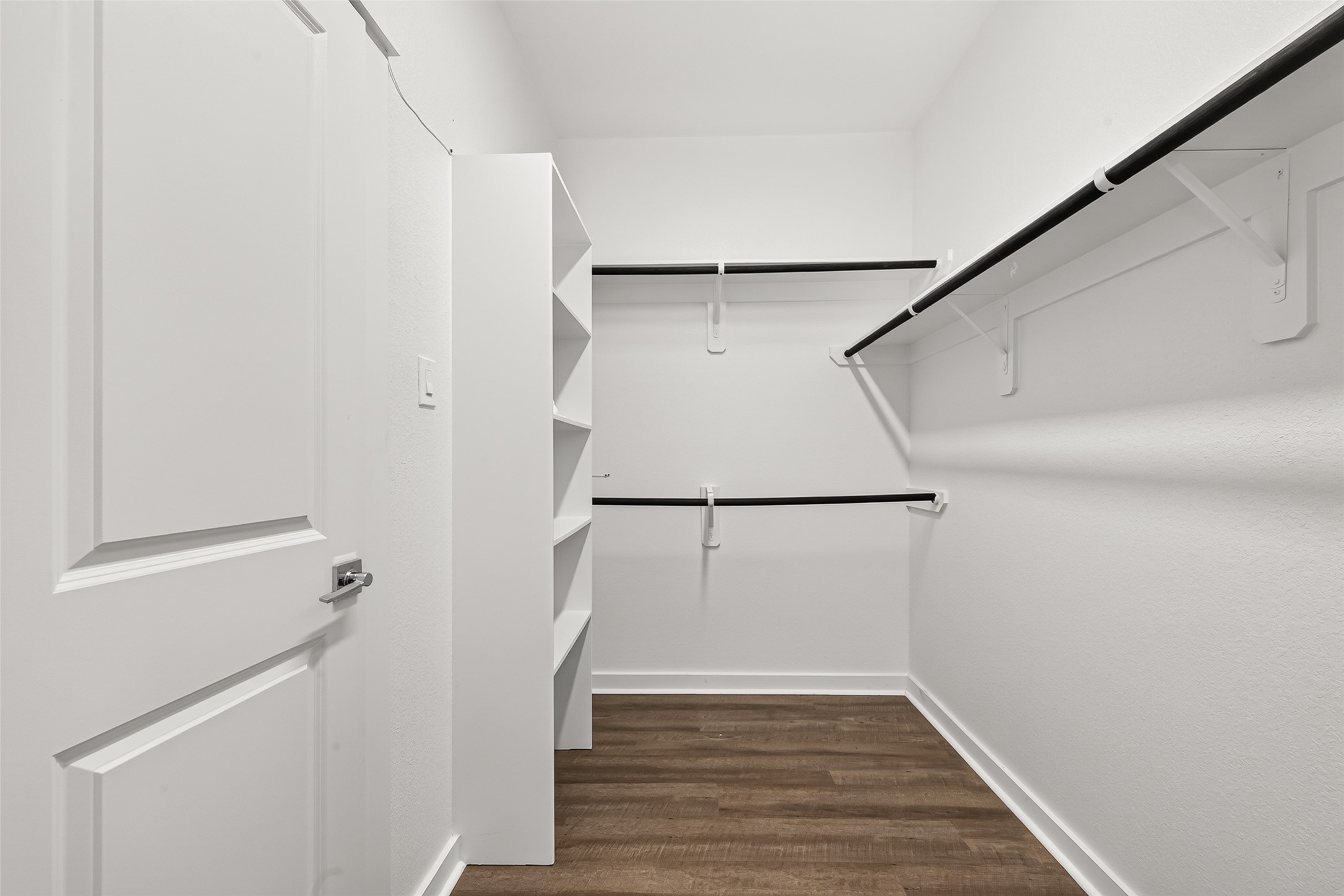 The primary walk-in closet provides hanging space and shelving to help keep clothing and accessories organized.