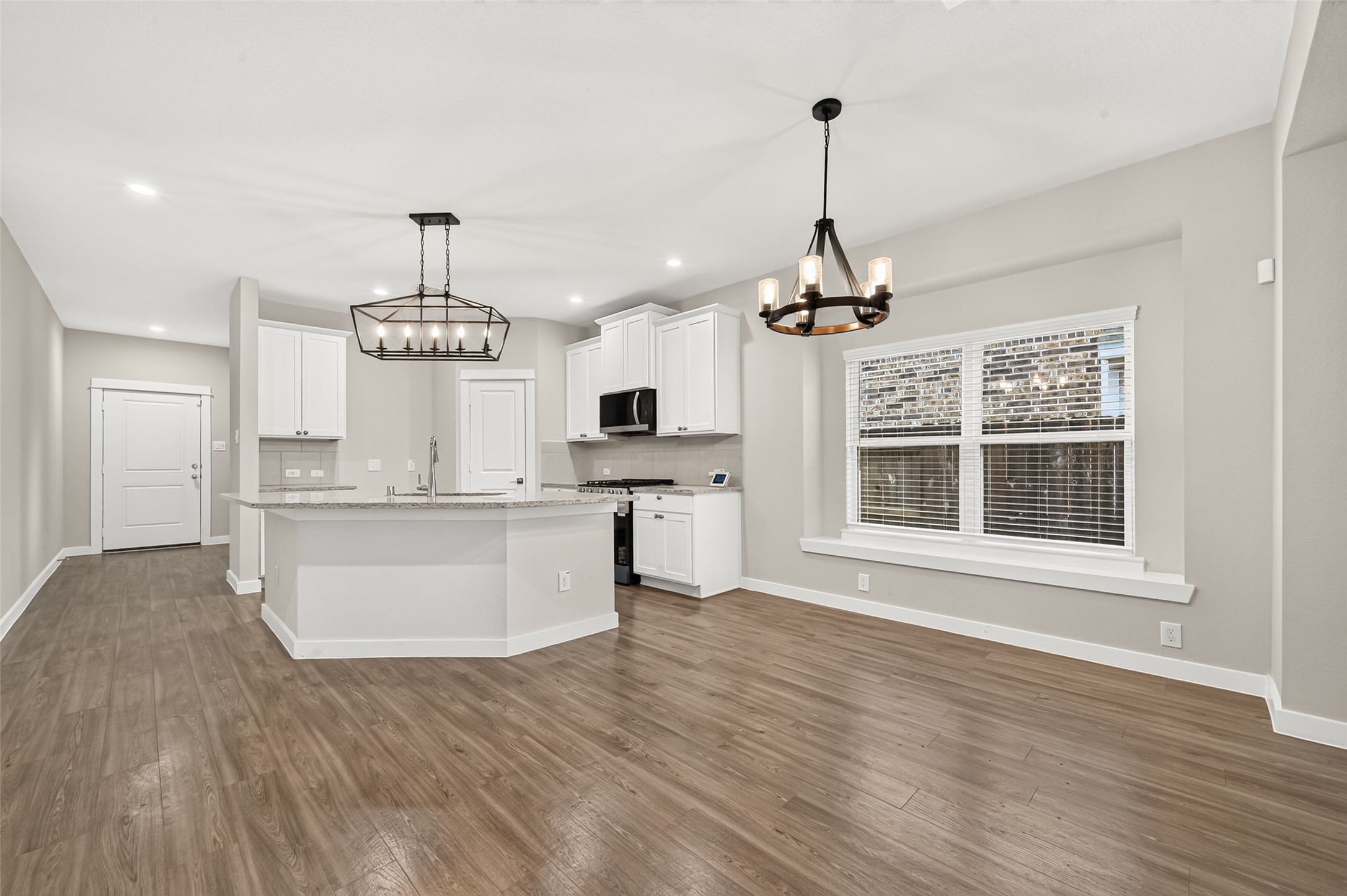 The dining area sits beside the kitchen and opens to the family room, keeping meals and gatherings connected.