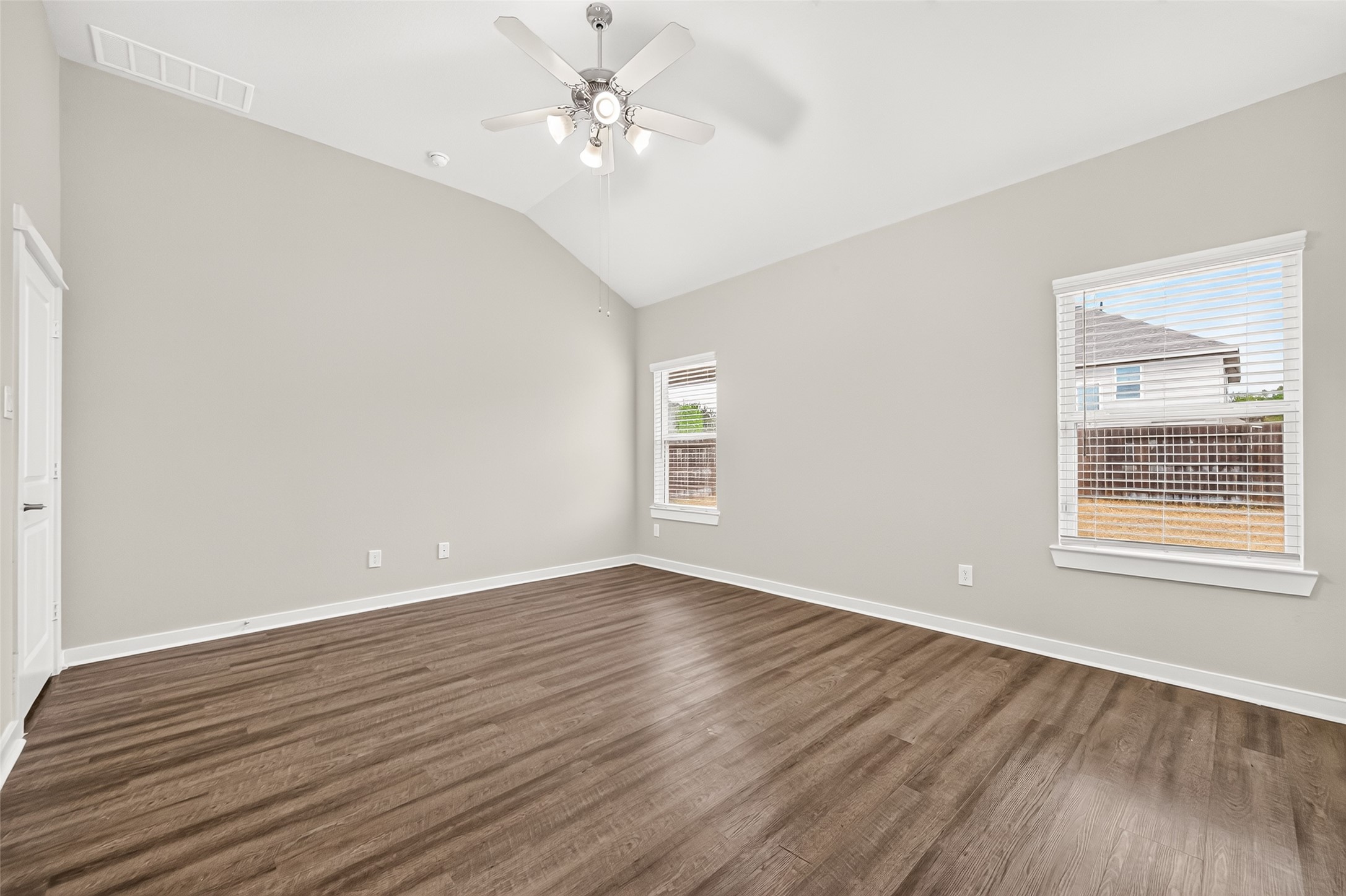 Another view of the primary suite highlights its natural light, neutral palette, and space for your furniture arrangement.
