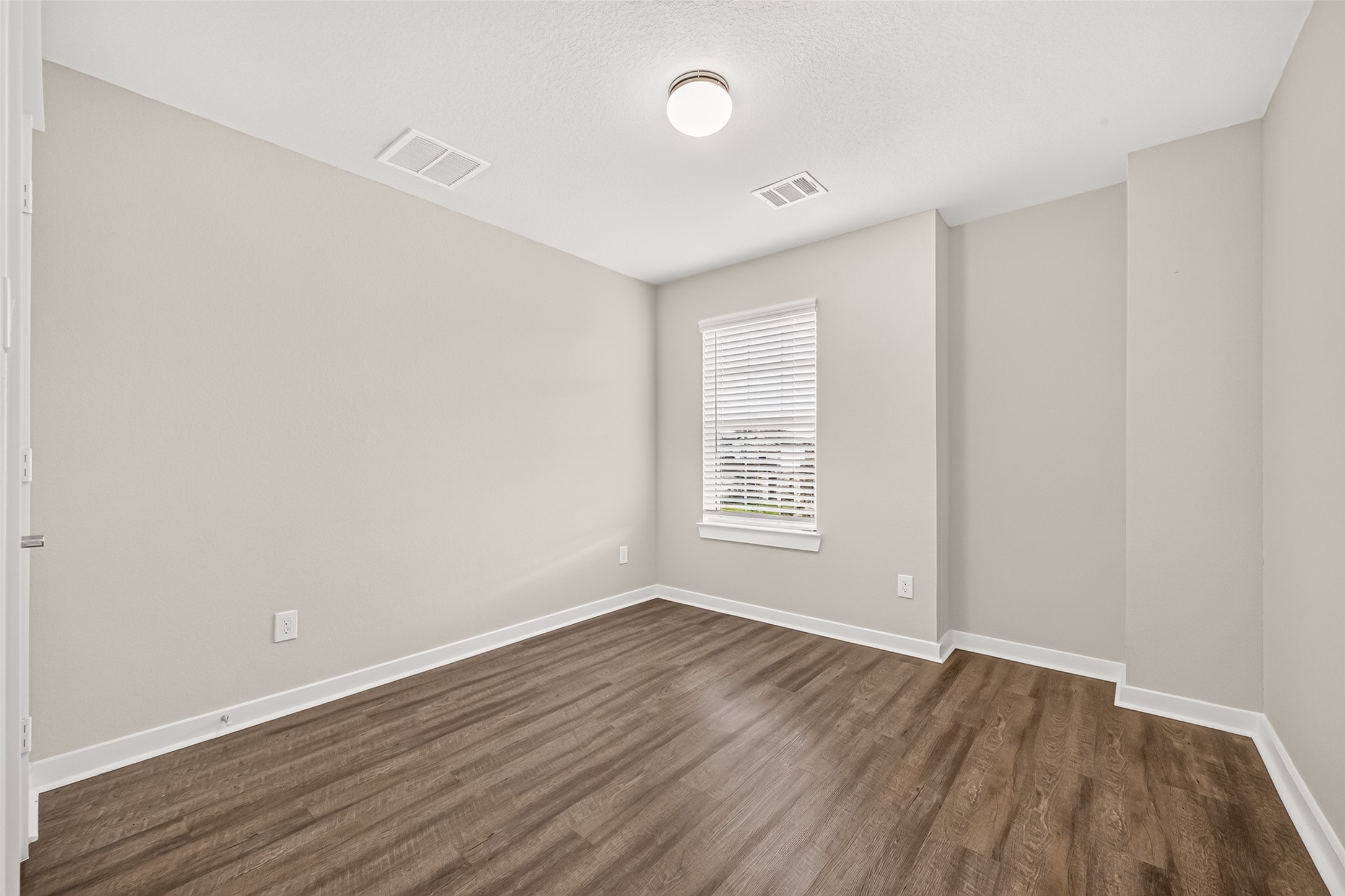 The third upstairs secondary bedroom provides additional space for guests, hobbies, or everyday living.