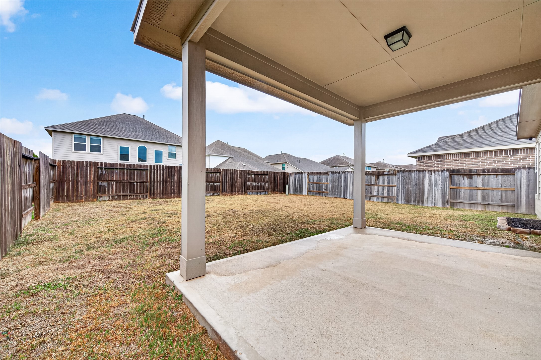 A brick archway and sheltered front entry create a welcoming approach to the home.