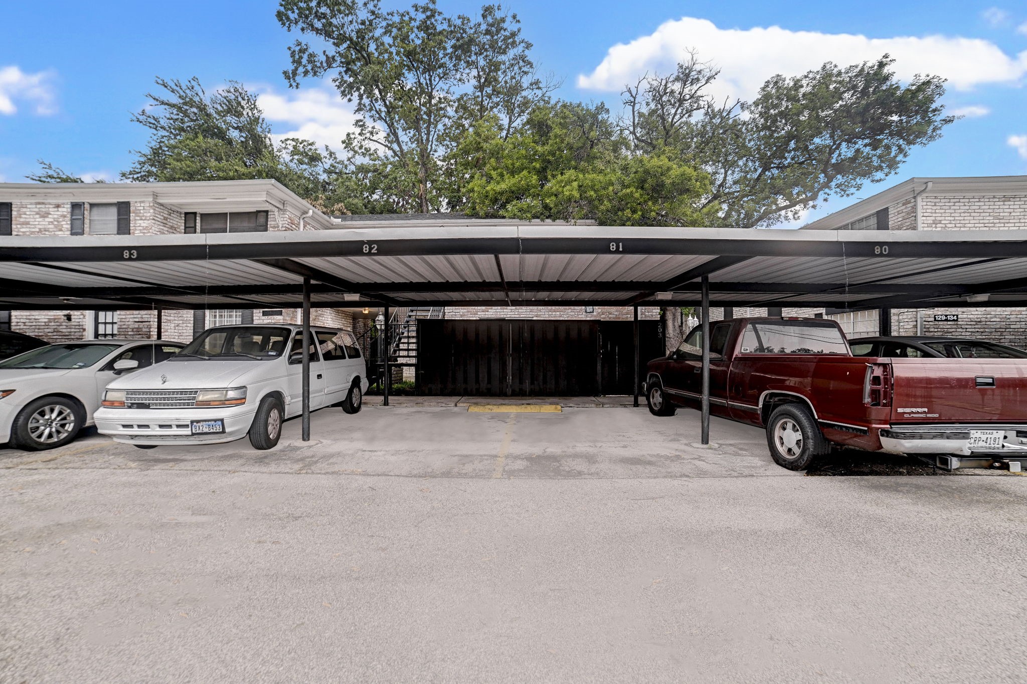 Covered parking area with multiple spaces and easy access to the building, providing convenience and protection for your vehicles.