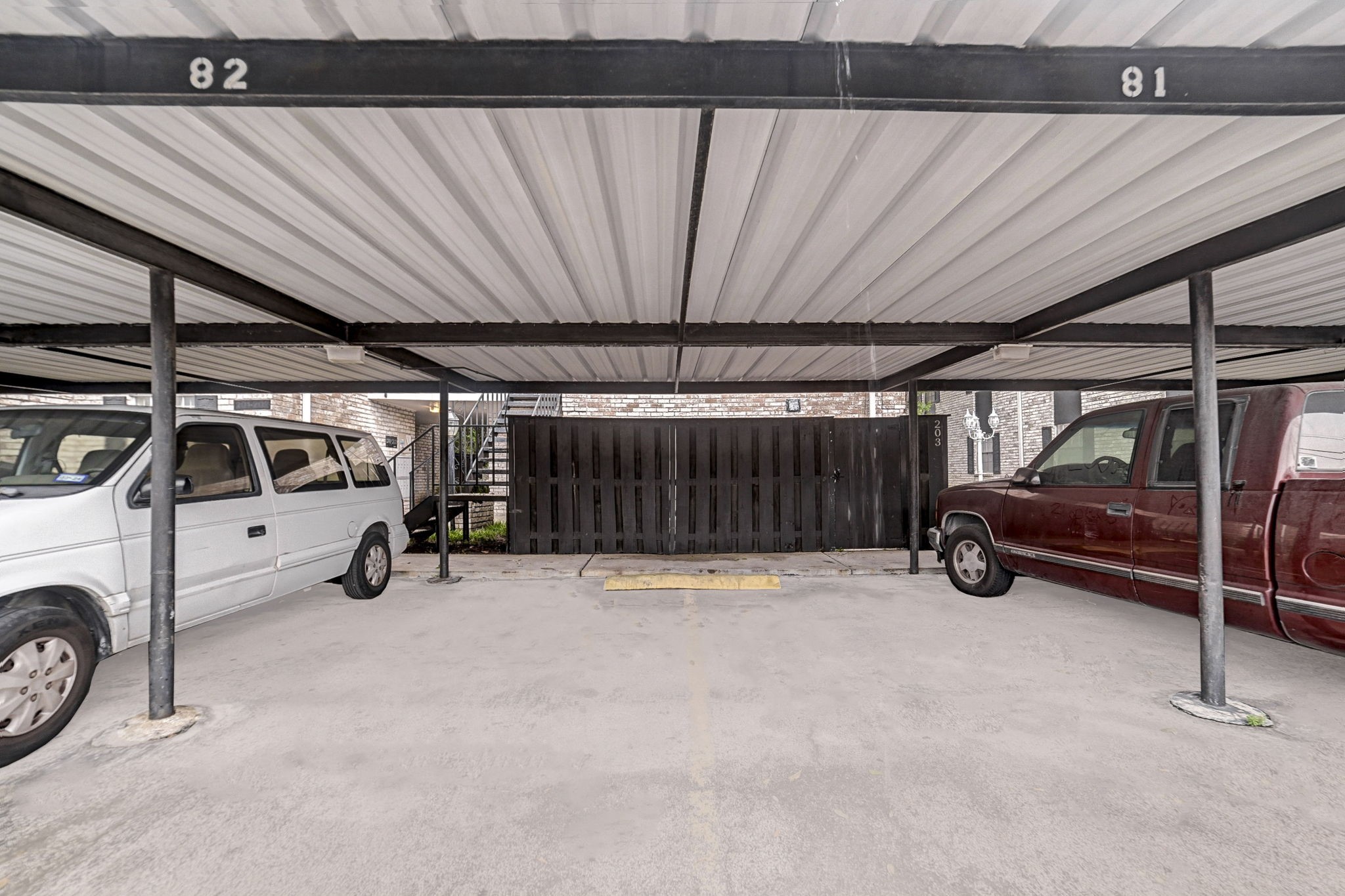 Covered parking area with designated spaces provides convenient and sheltered vehicle storage.