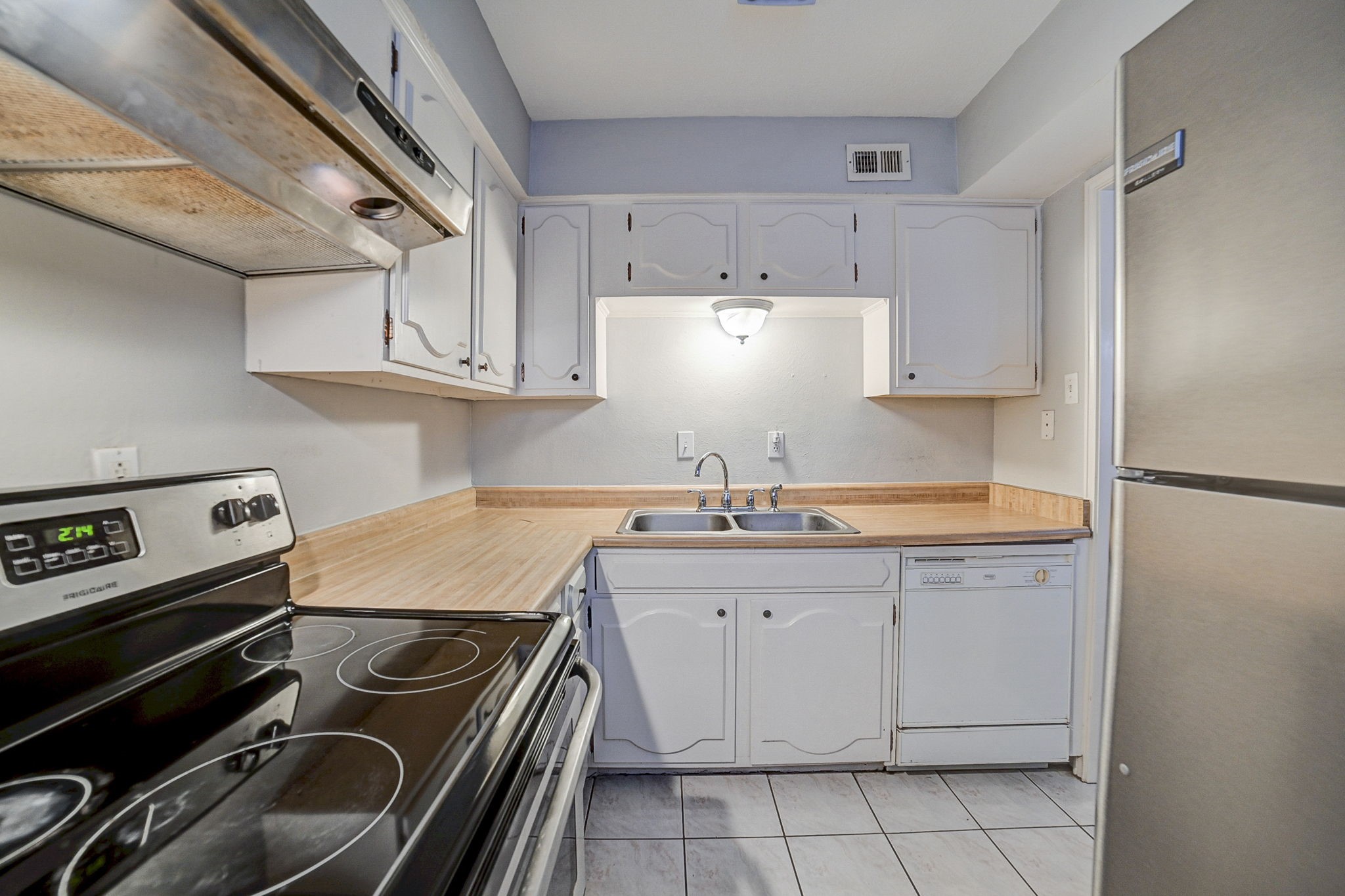 Charming kitchen with modern stainless steel appliances, ample cabinetry, and a cozy layout perfect for culinary creativity.