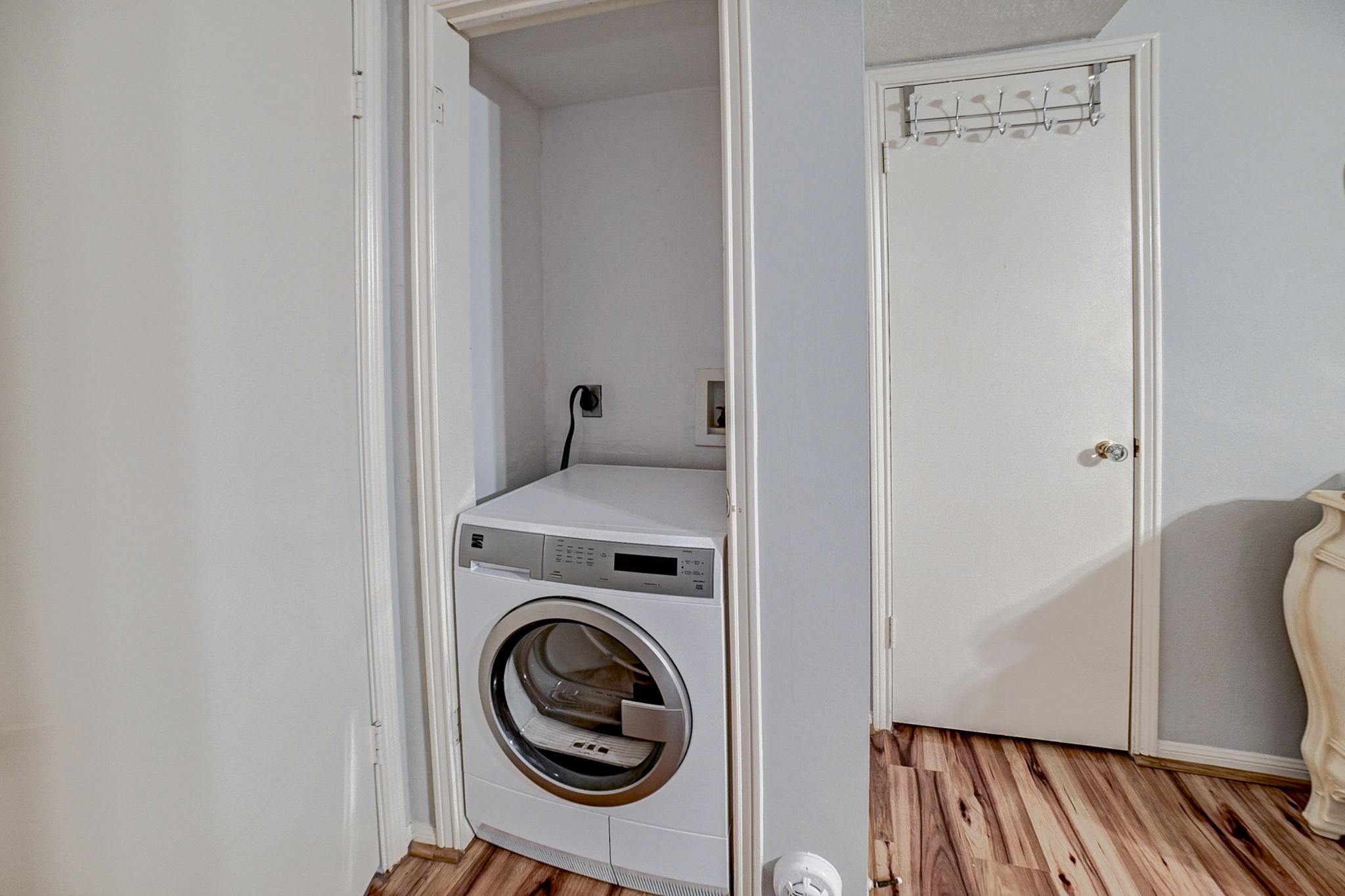 Convenient laundry nook with a modern washer and dryer set, seamlessly integrated into a compact space with easy access.