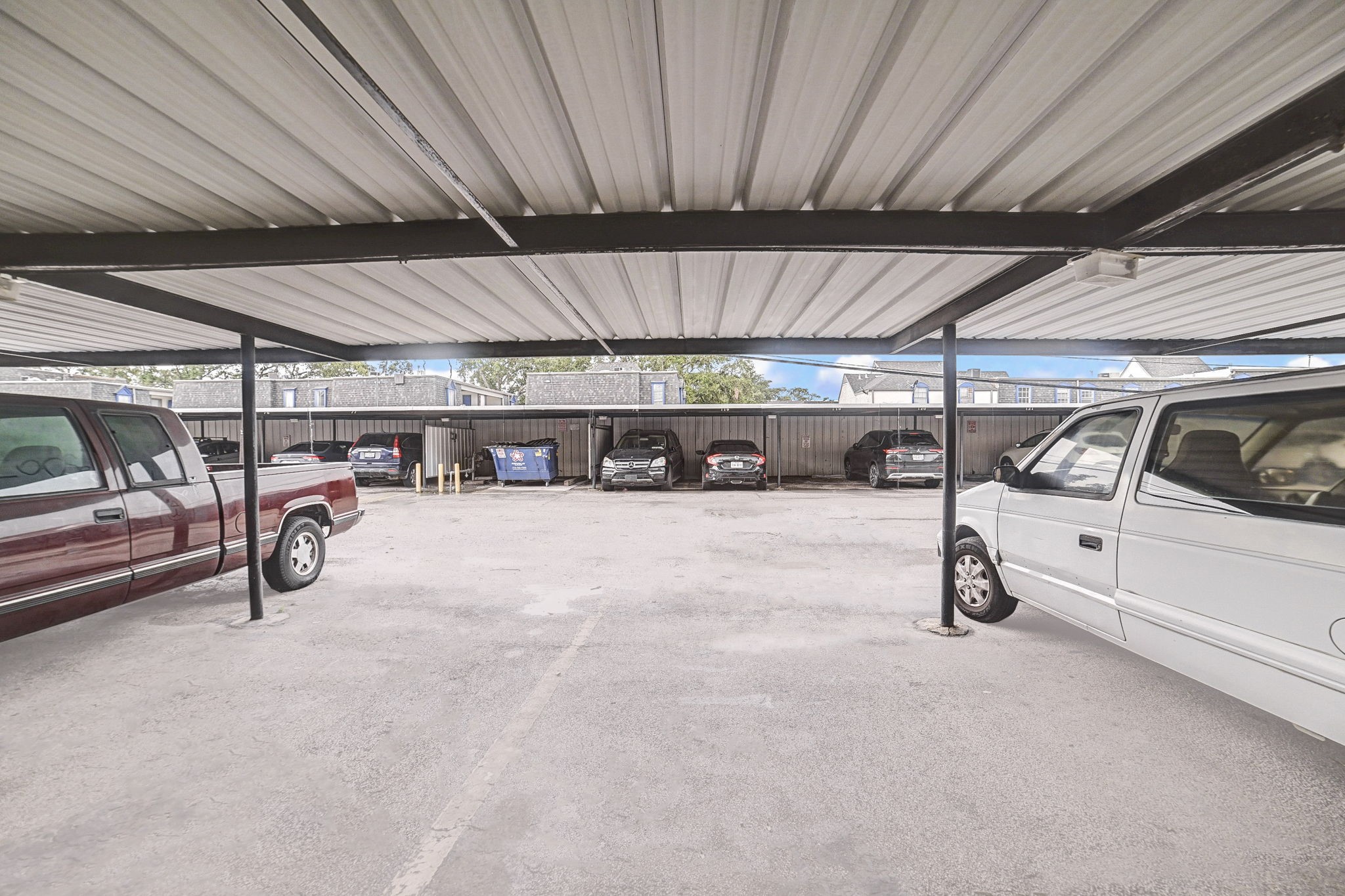 Covered parking area offering protection from the elements, accommodating multiple vehicles in a secure setting.