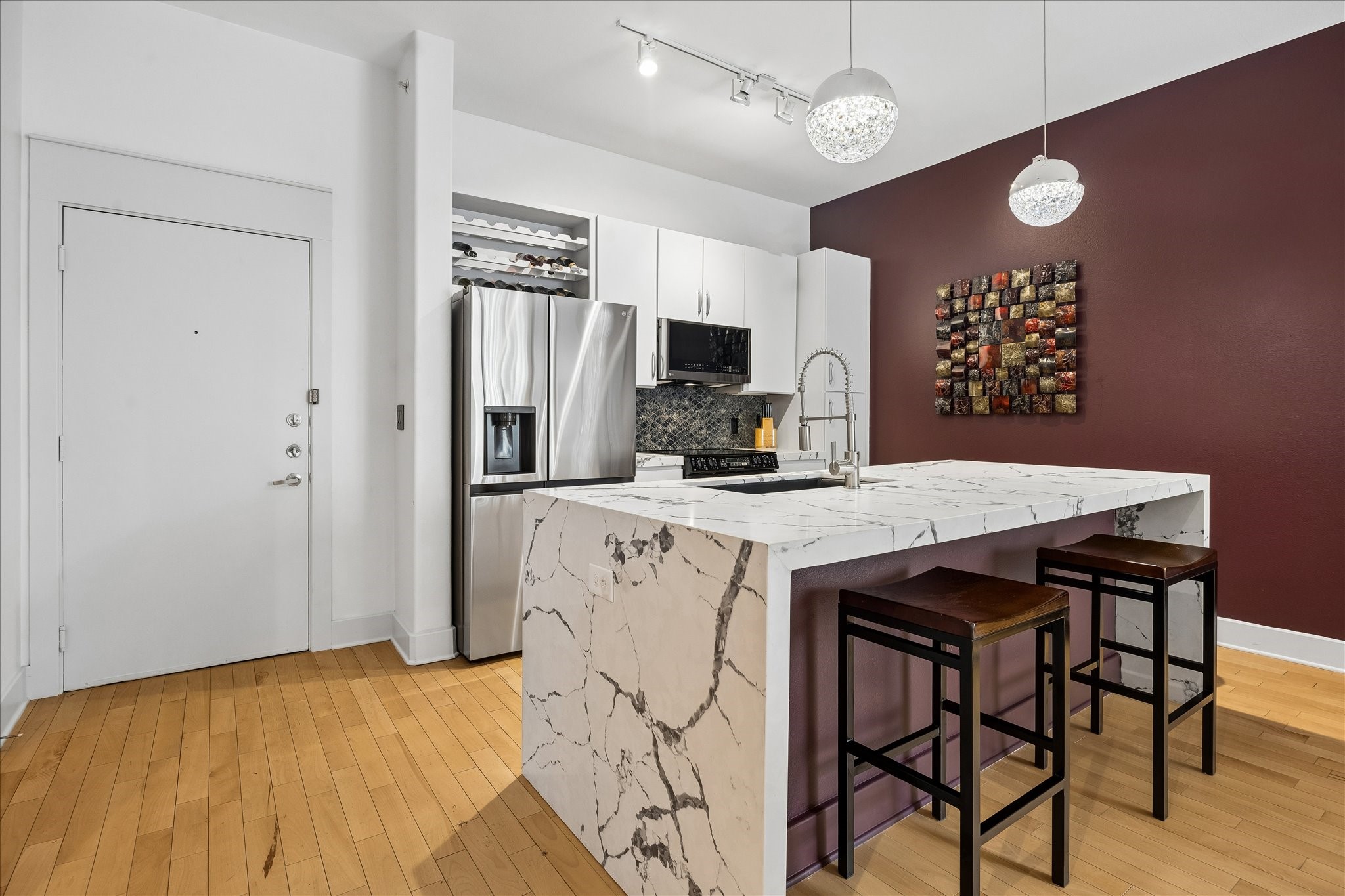 Waterfall quartz island with seating, designer backsplash and updated kitchen finishes. Waterfall quartz island with seating, designer backsplash and updated kitchen finishes.