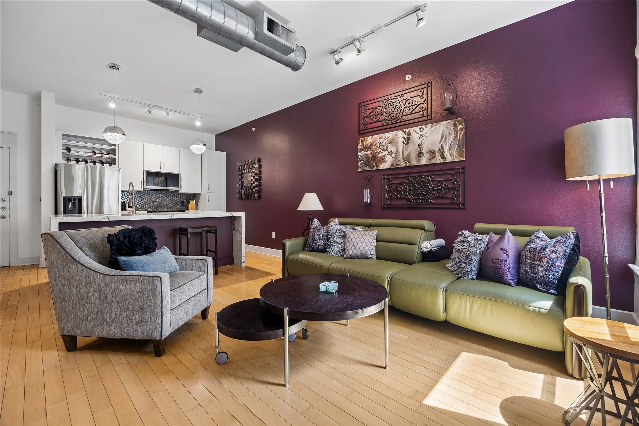 Renovated interior with hardwood floors, high ceilings and exposed ductwork.
