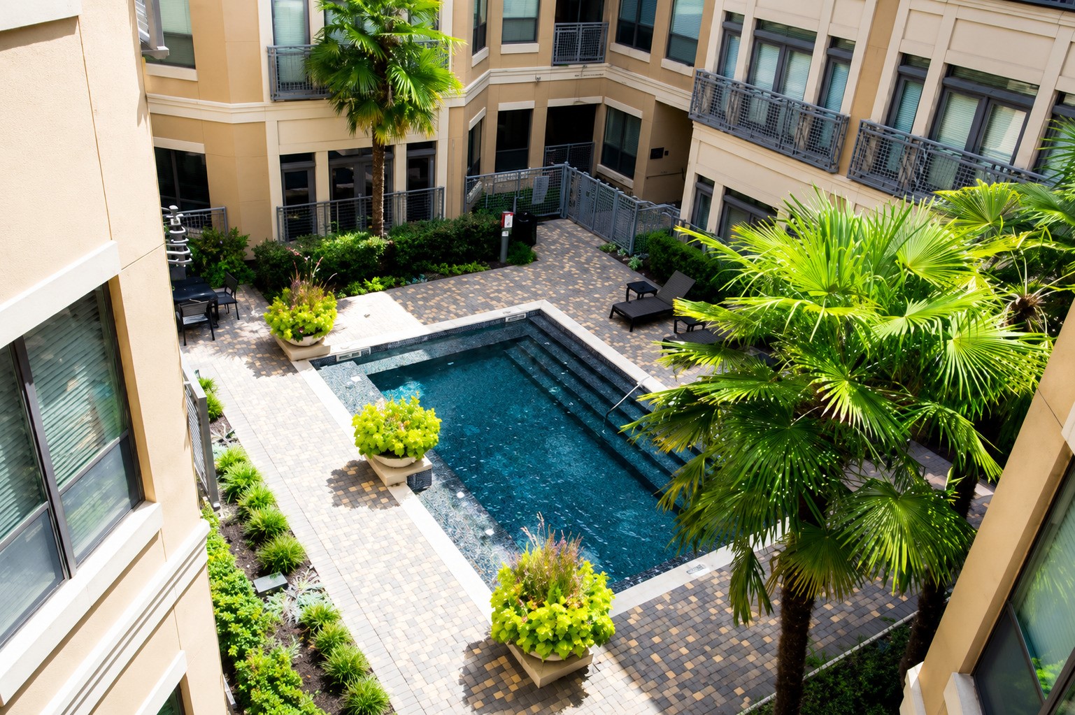 Pool view from the private covered balcony. The Lofts on Post Oak features six pools throughout the community.