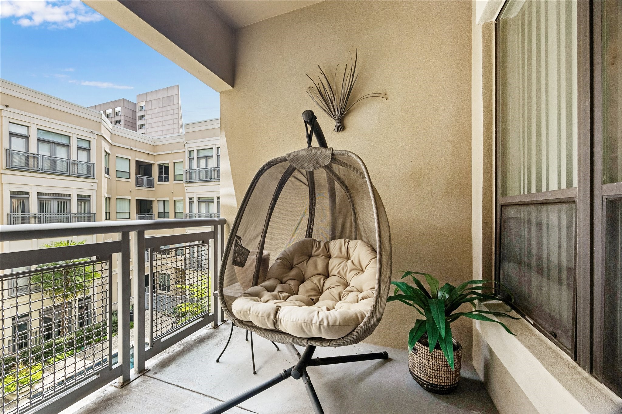 Covered private balcony overlooking the pool courtyard.