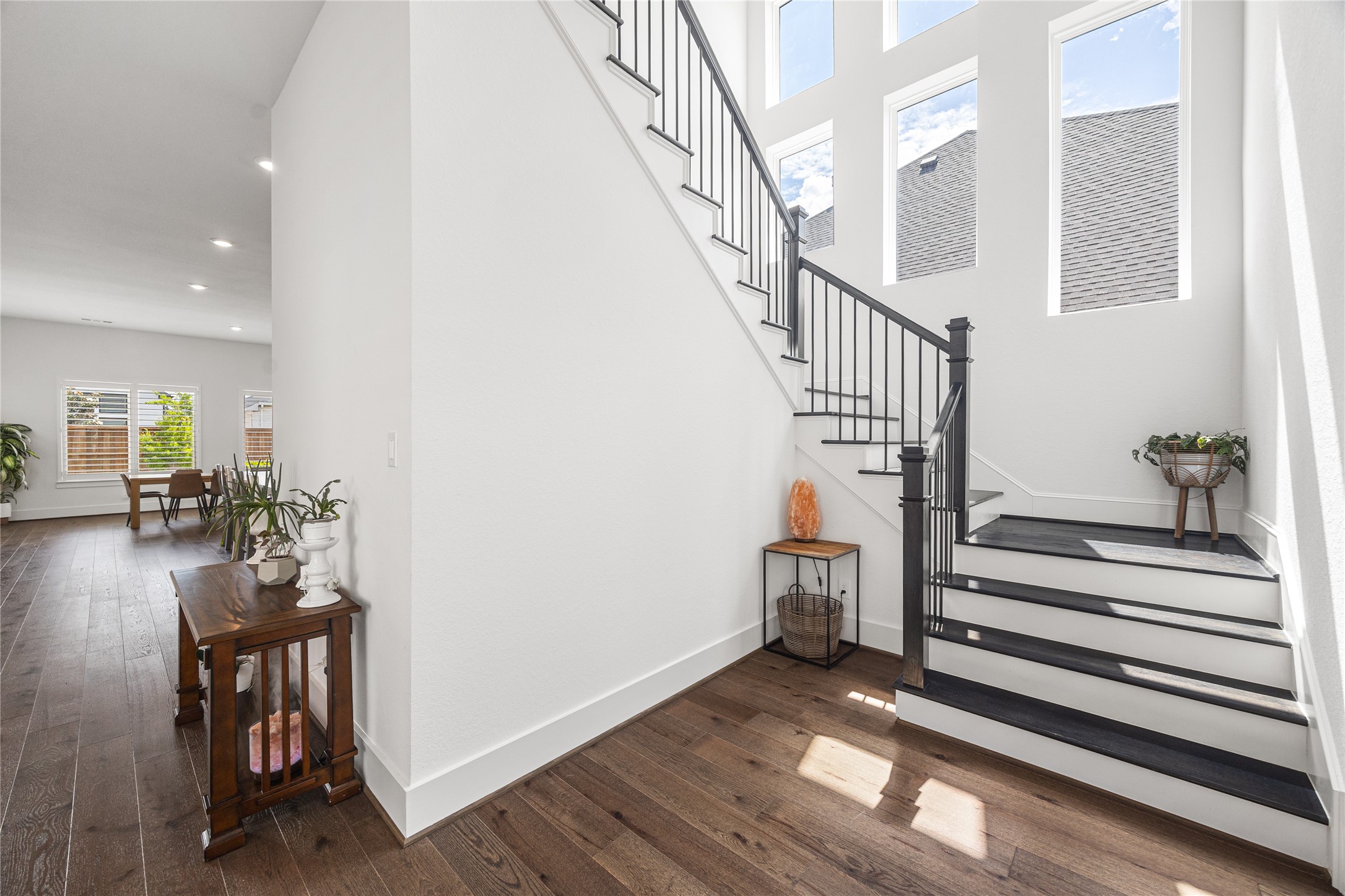 Wood flooring on the stairs and gorgeous windows with plenty of natural light.