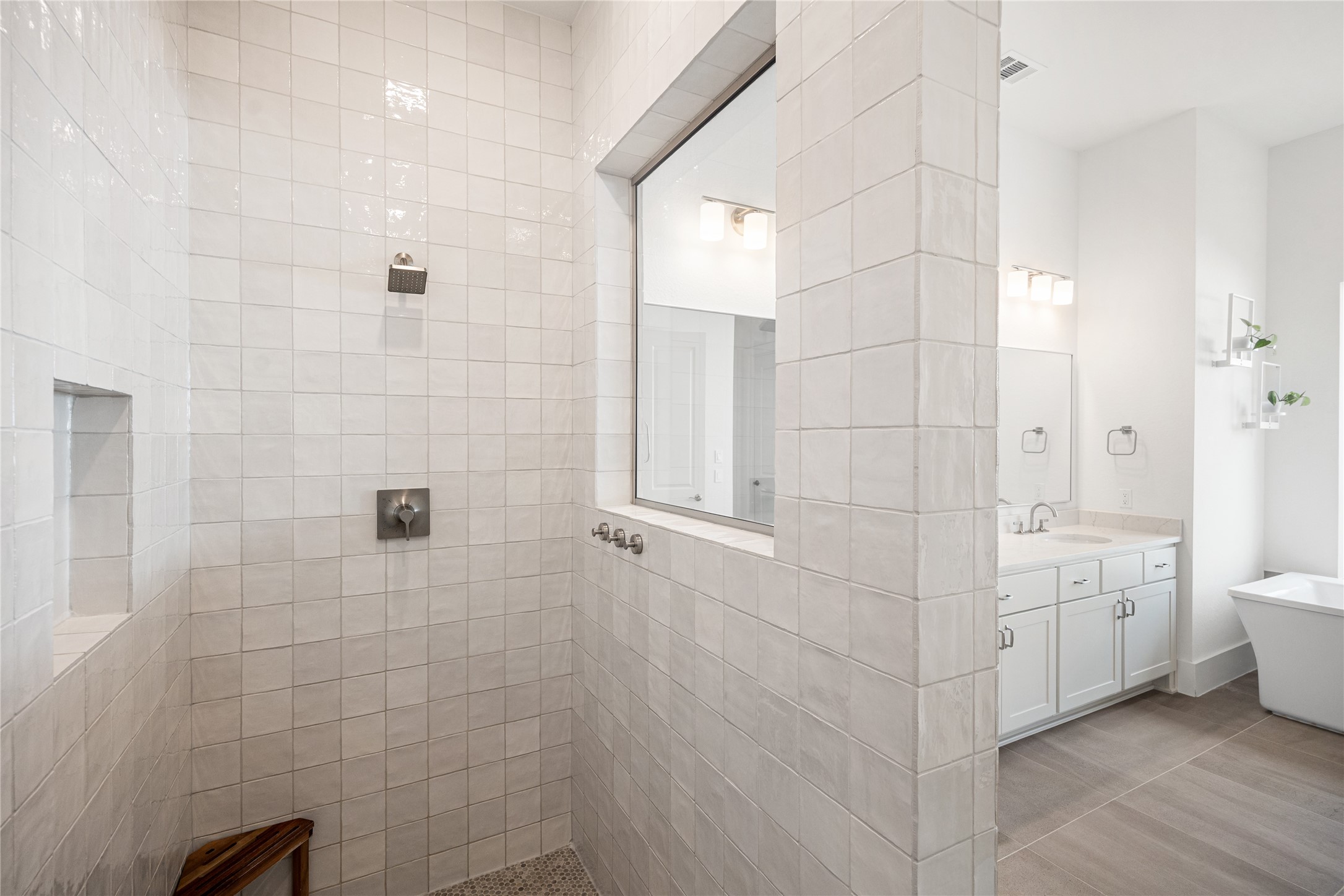 Upgraded oversized shower featuring stunning tile work, creating a spa-like retreat with both style and comfort.