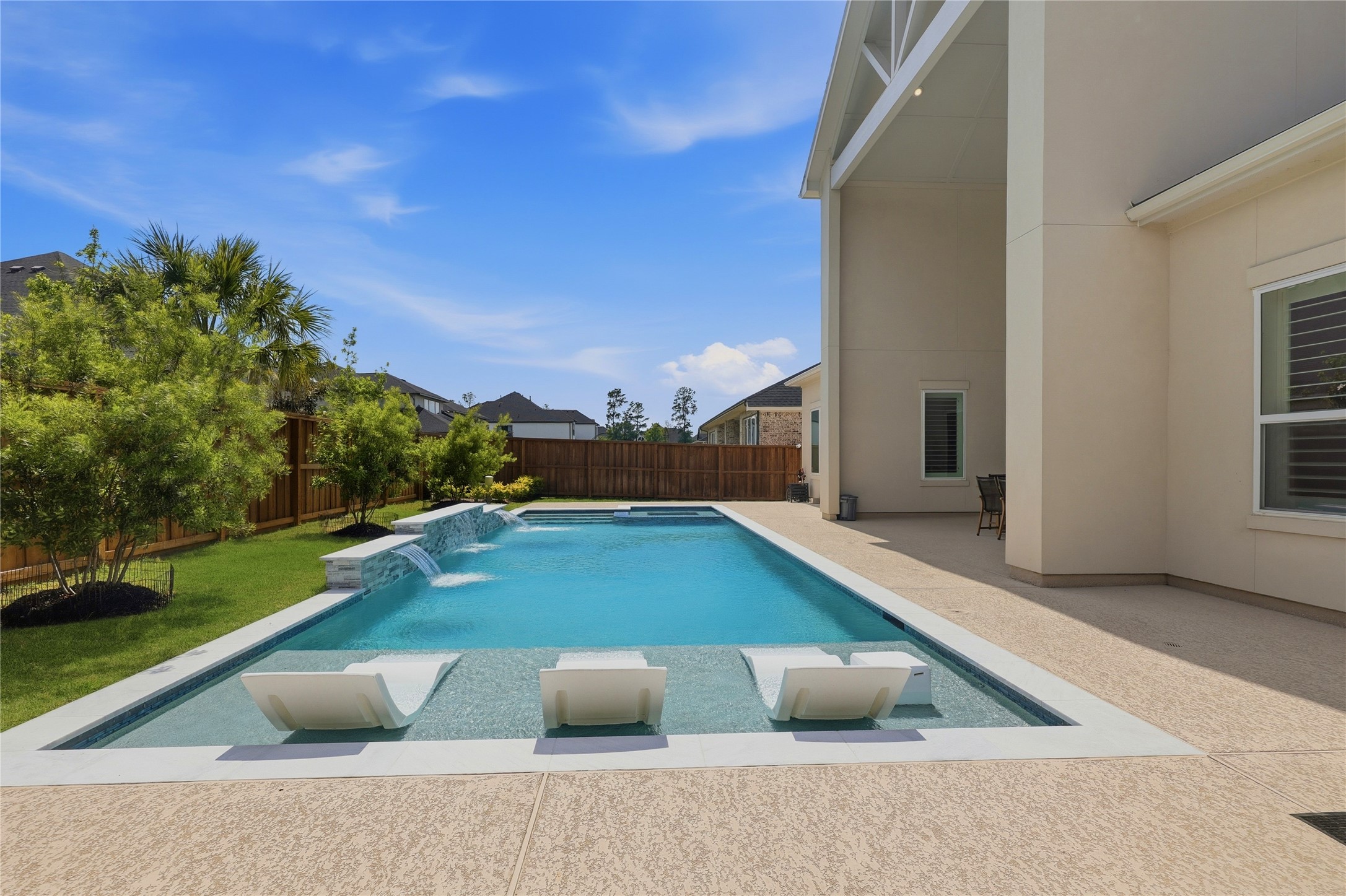 Sports Pool with tanning ledge and spa. This pool includes a heater and chiller!