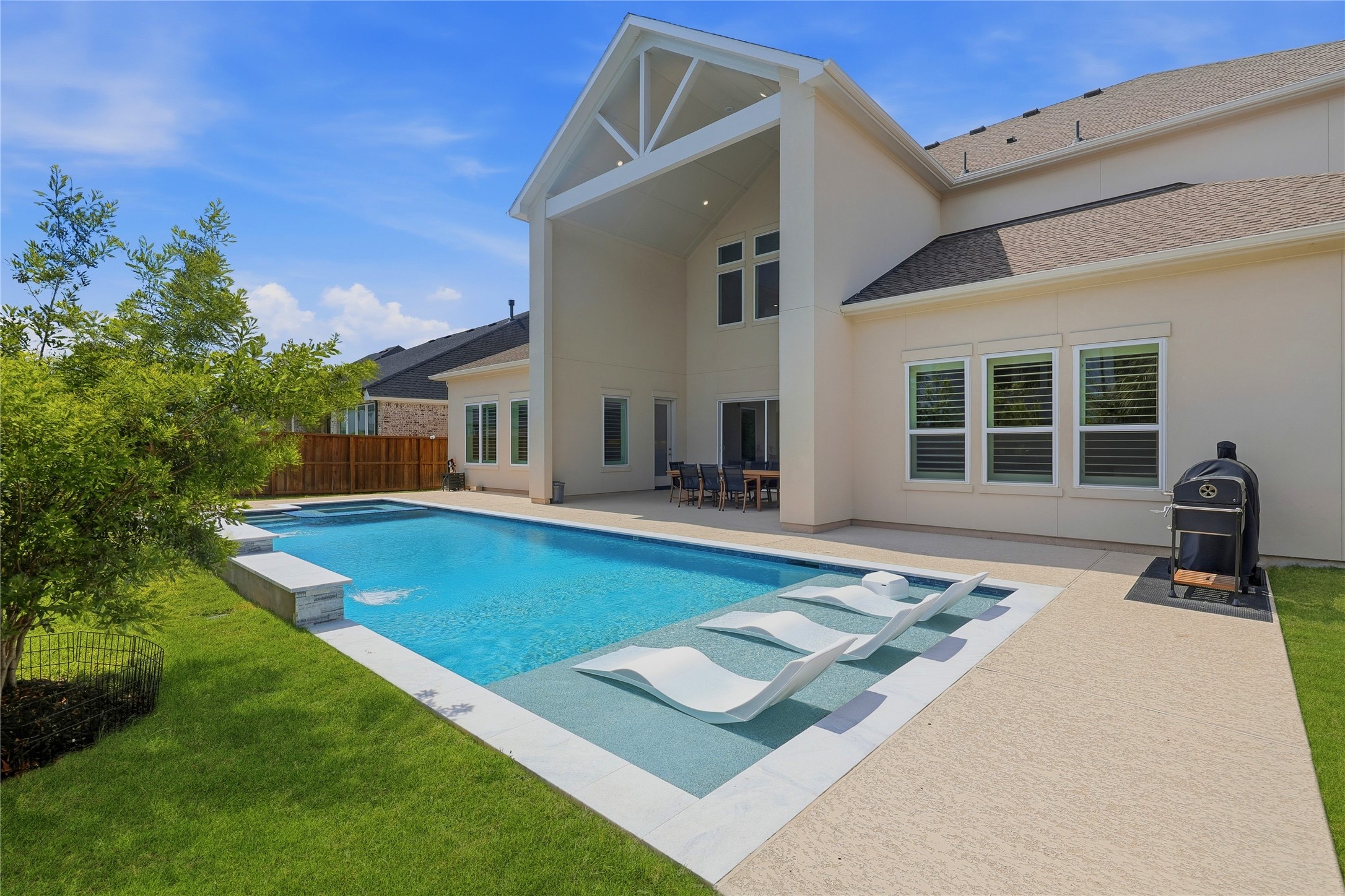 Sports pool with tanning ledge.