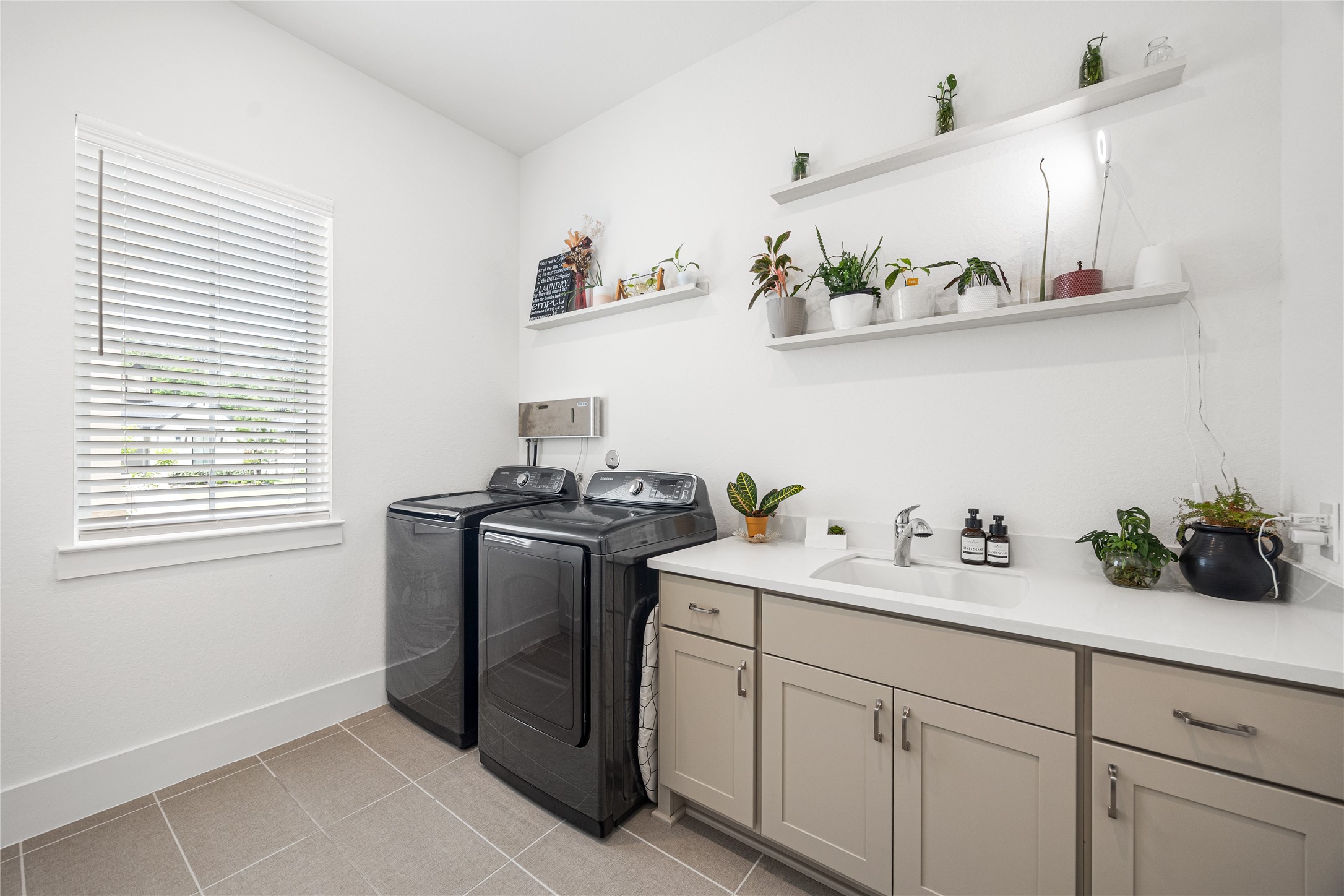 Laundry room with sink and cabinets.