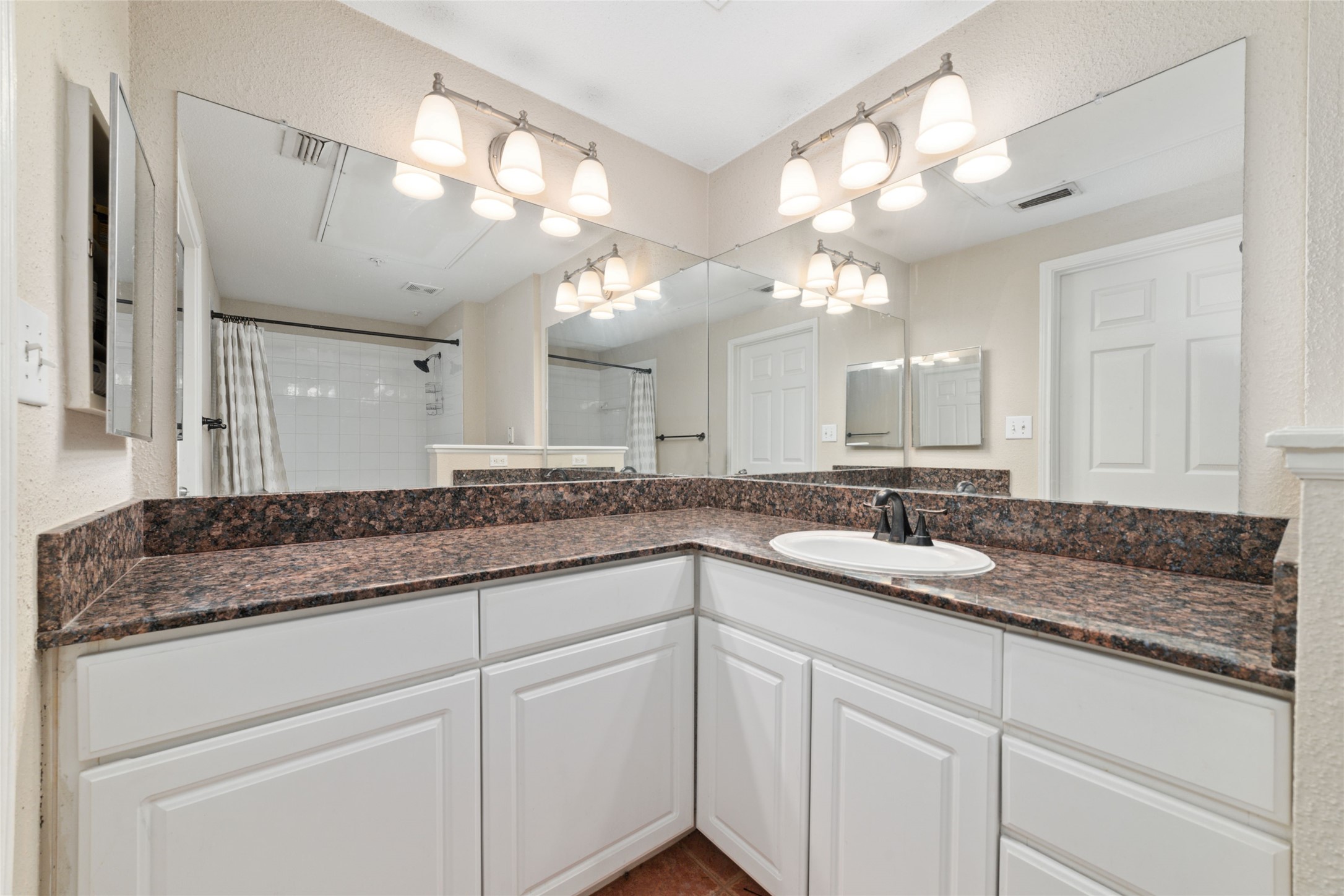 Bright and clean bathroom featuring elegant finishes, plenty of storage, and a spa-like feel.
