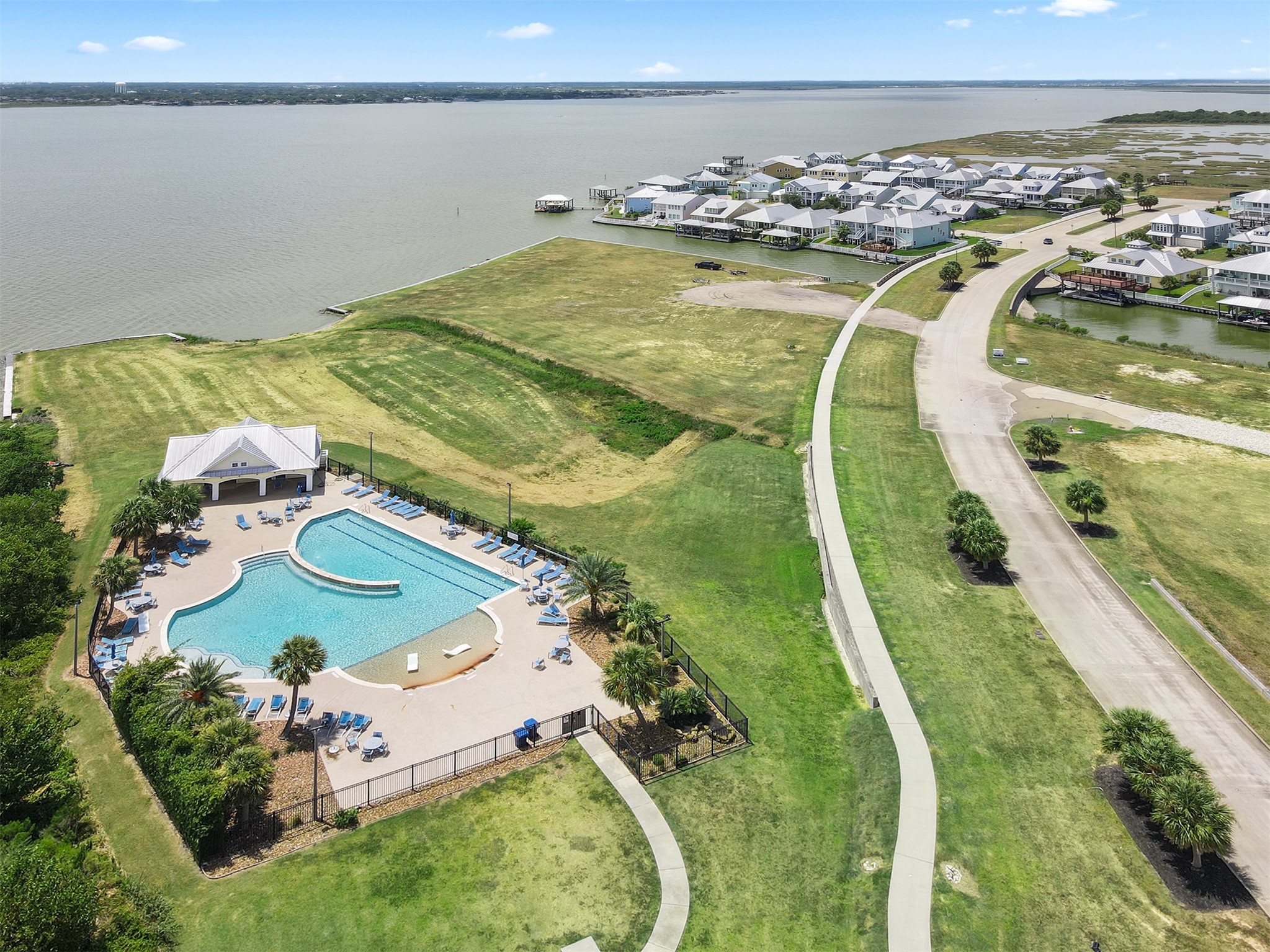 Community pool in the foreground and boat launch in the background.