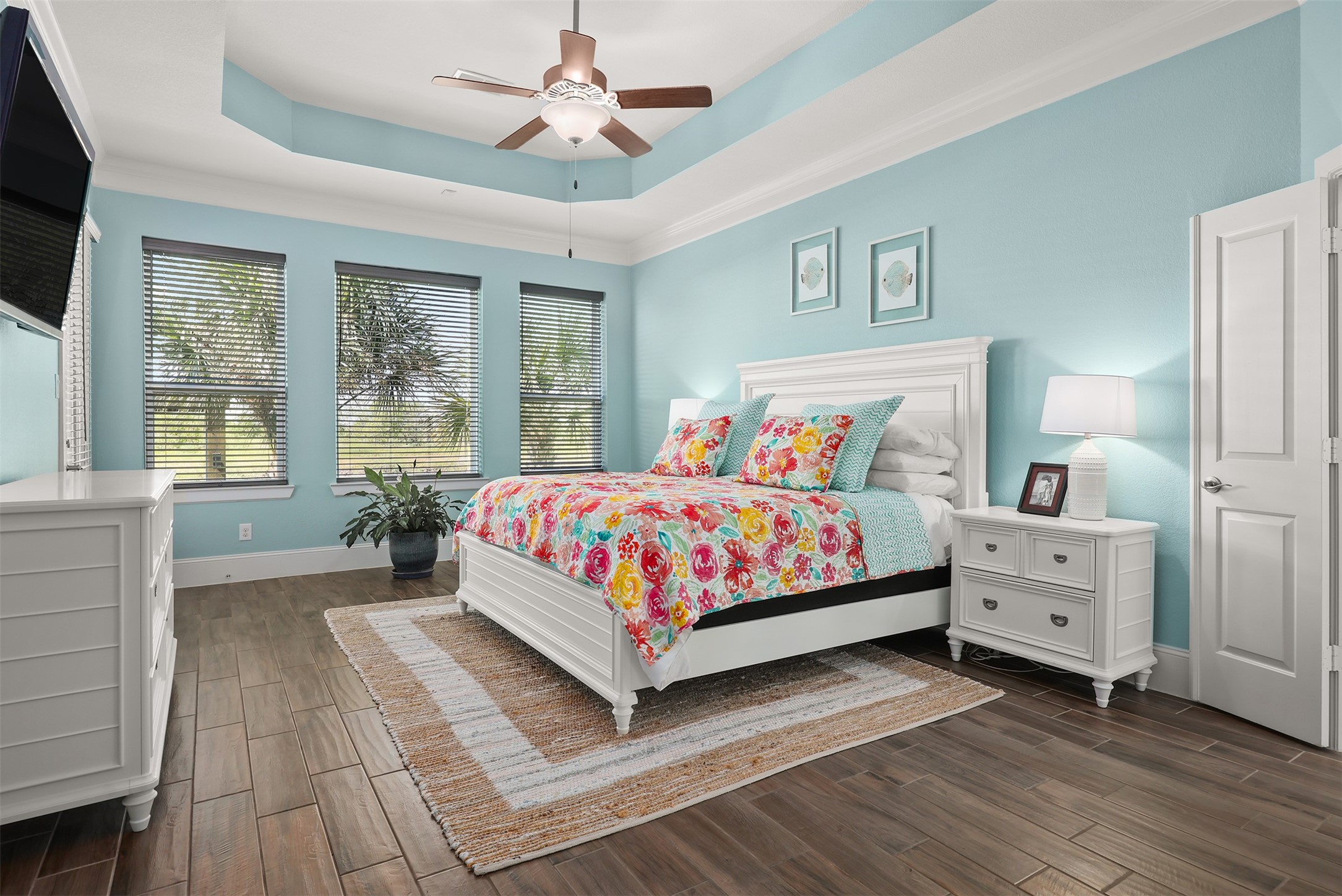 Primary bedroom with an exterior door to the left that leads to the back patio.