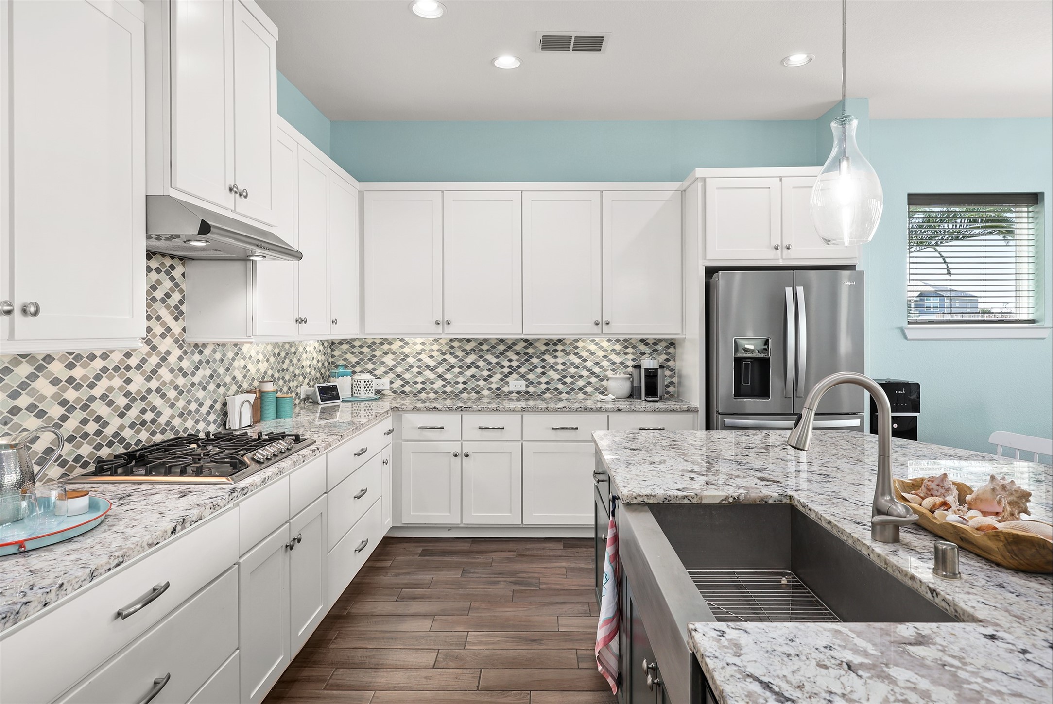 Custom backsplash, stainless appliances and under cabinet lighting.