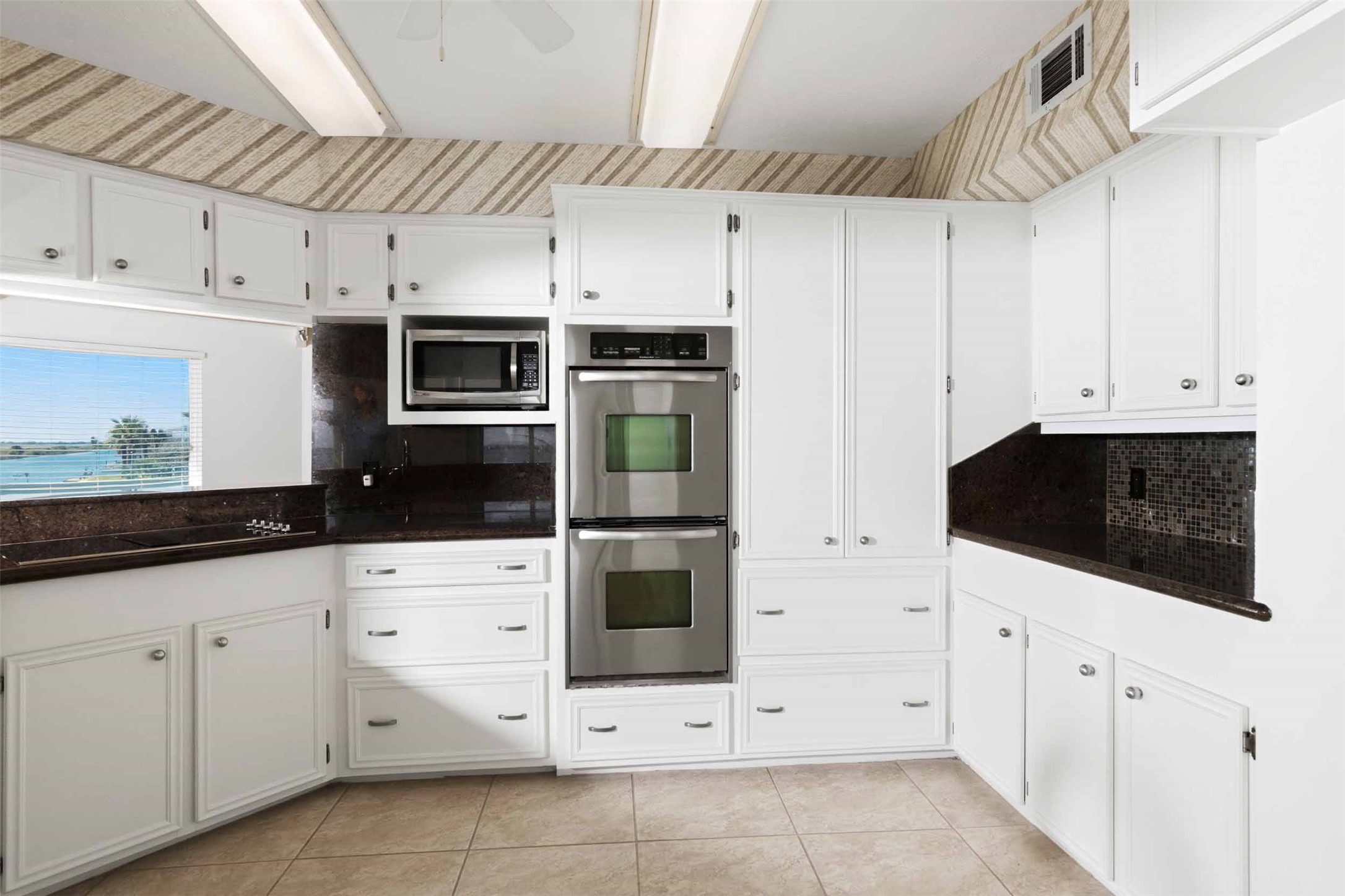 Open kitchen with beautiful granite countertops.