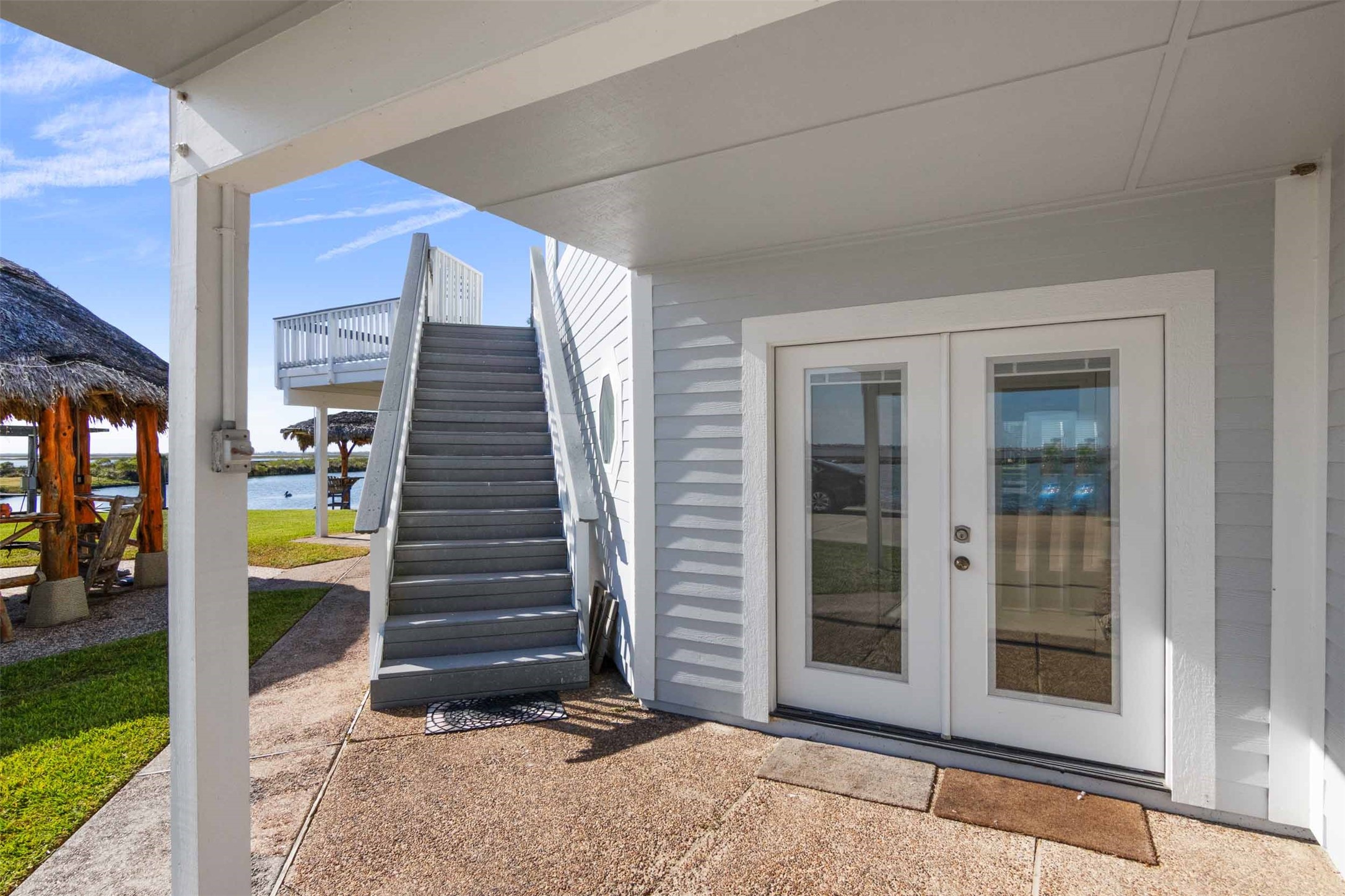 French doors into living area downstairs and outside stairs to second level.