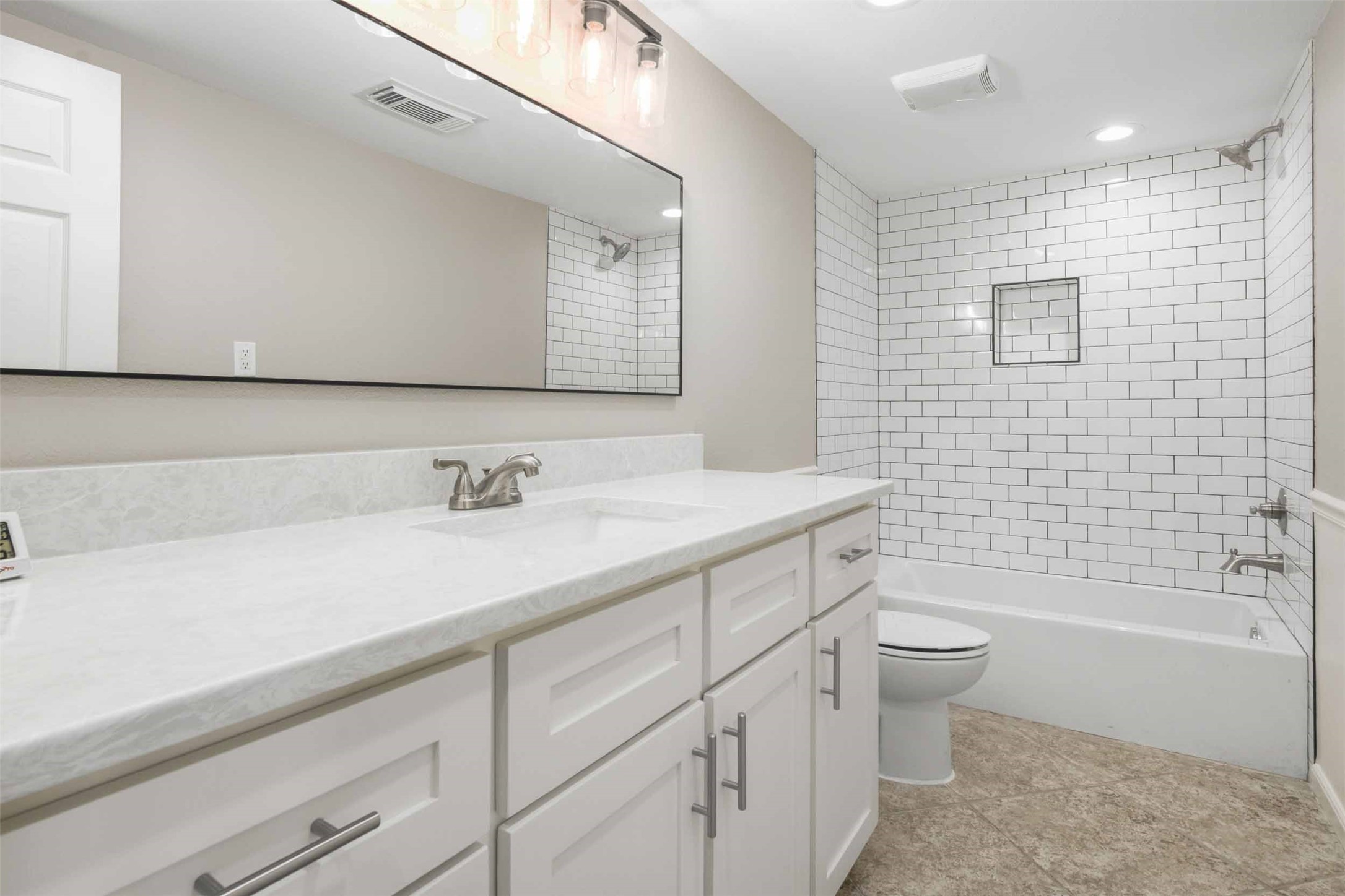 Updated bathroom with beautiful quartz countertops.