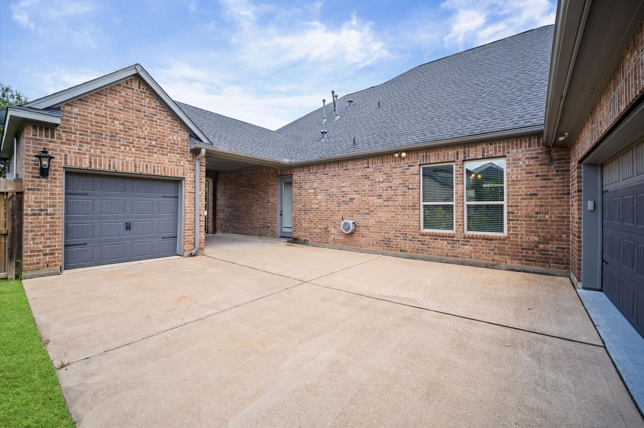 The porte-cochre offers a shaded parking spot for you or a guest. As you pass through it, you'll find a two-car garage across from a single-car garage. This set up is perfect for boat owners, golf carts, or a workshop.