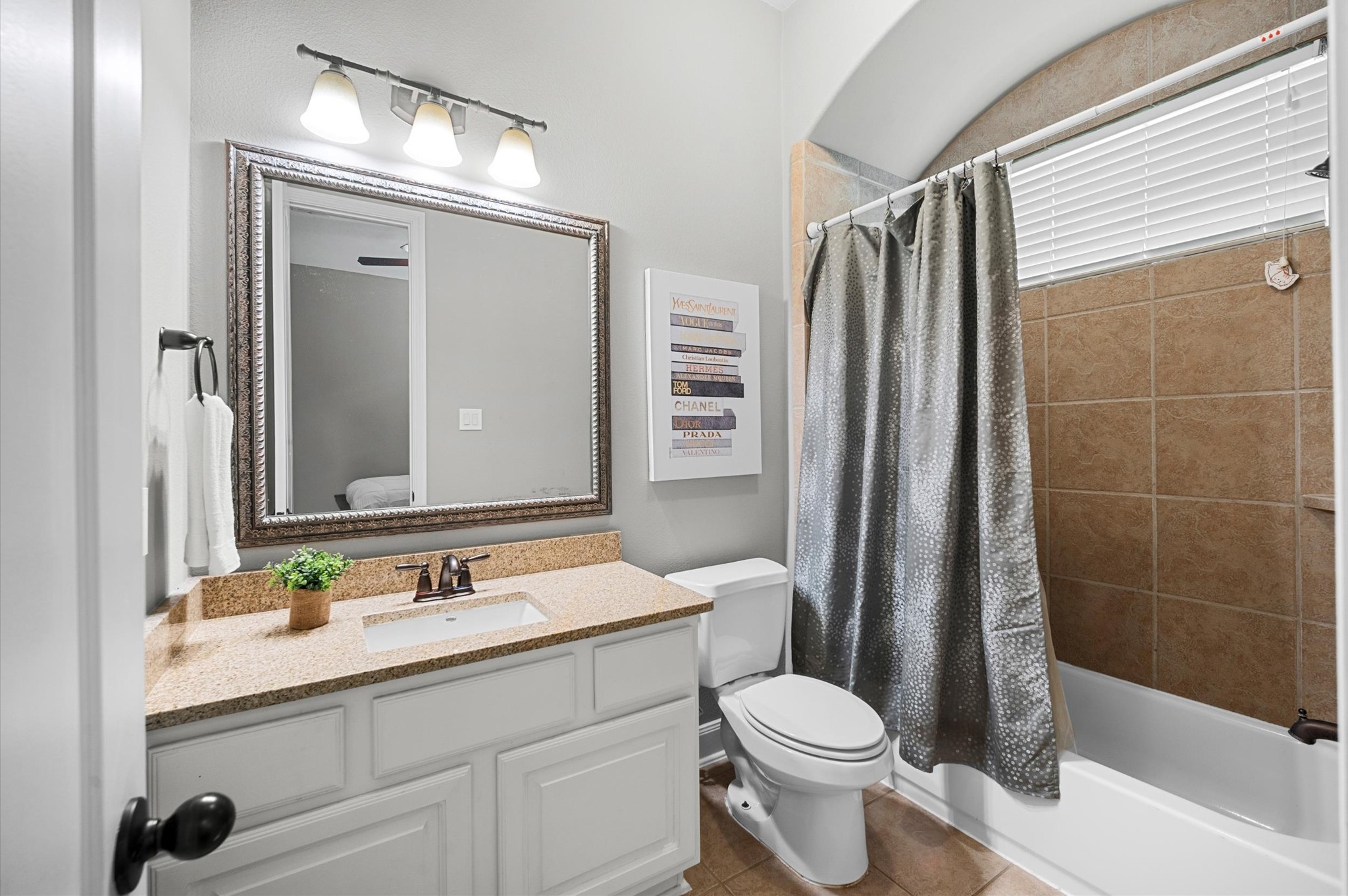 The attached bathroom for Bedroom 2 features a tub and shower combination.
