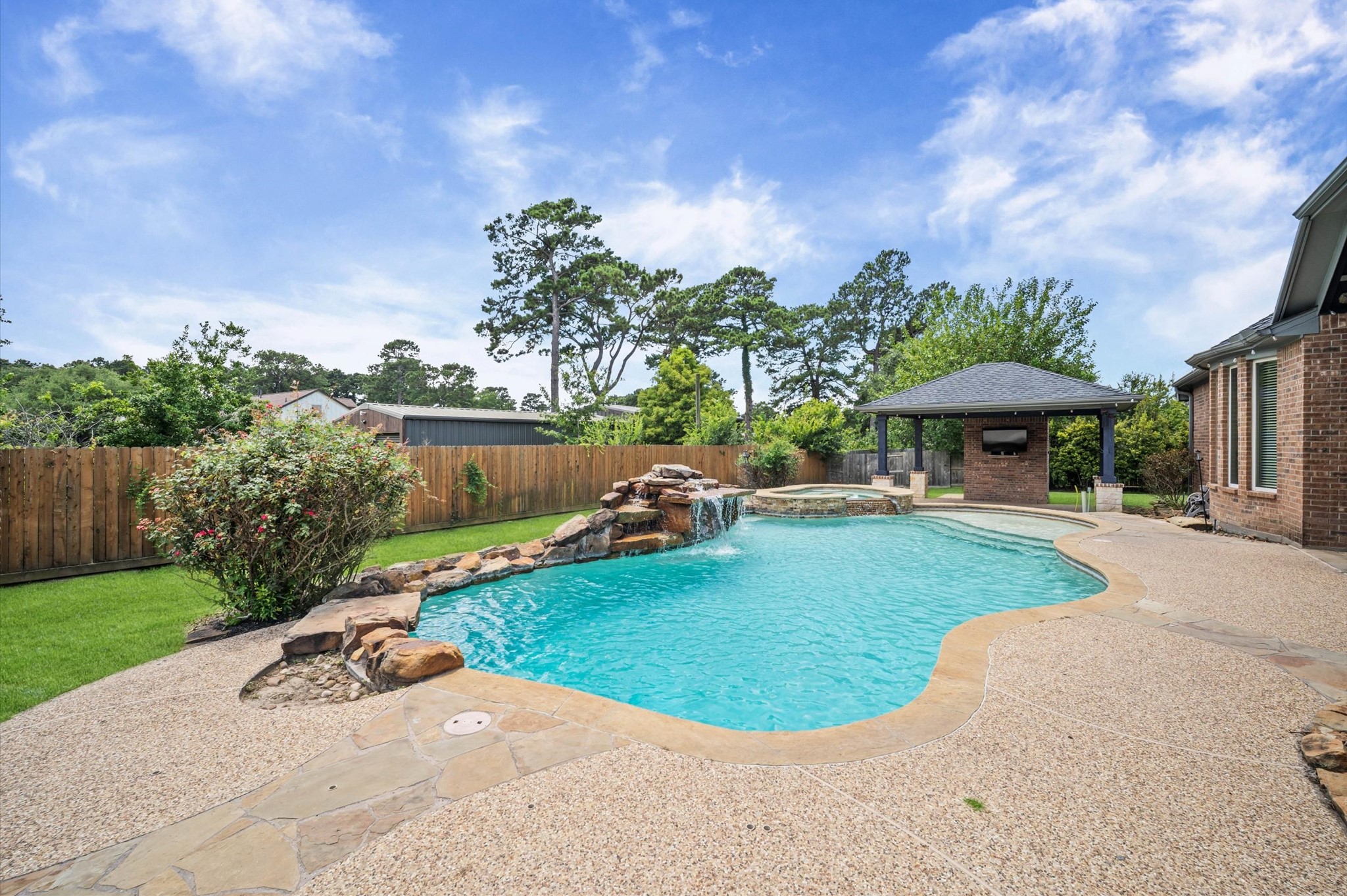 Paradise awaits in this incredible backyard! Whether you sunbathe, relax in the shade, or take a refreshing swim, you'll love this private oasis.