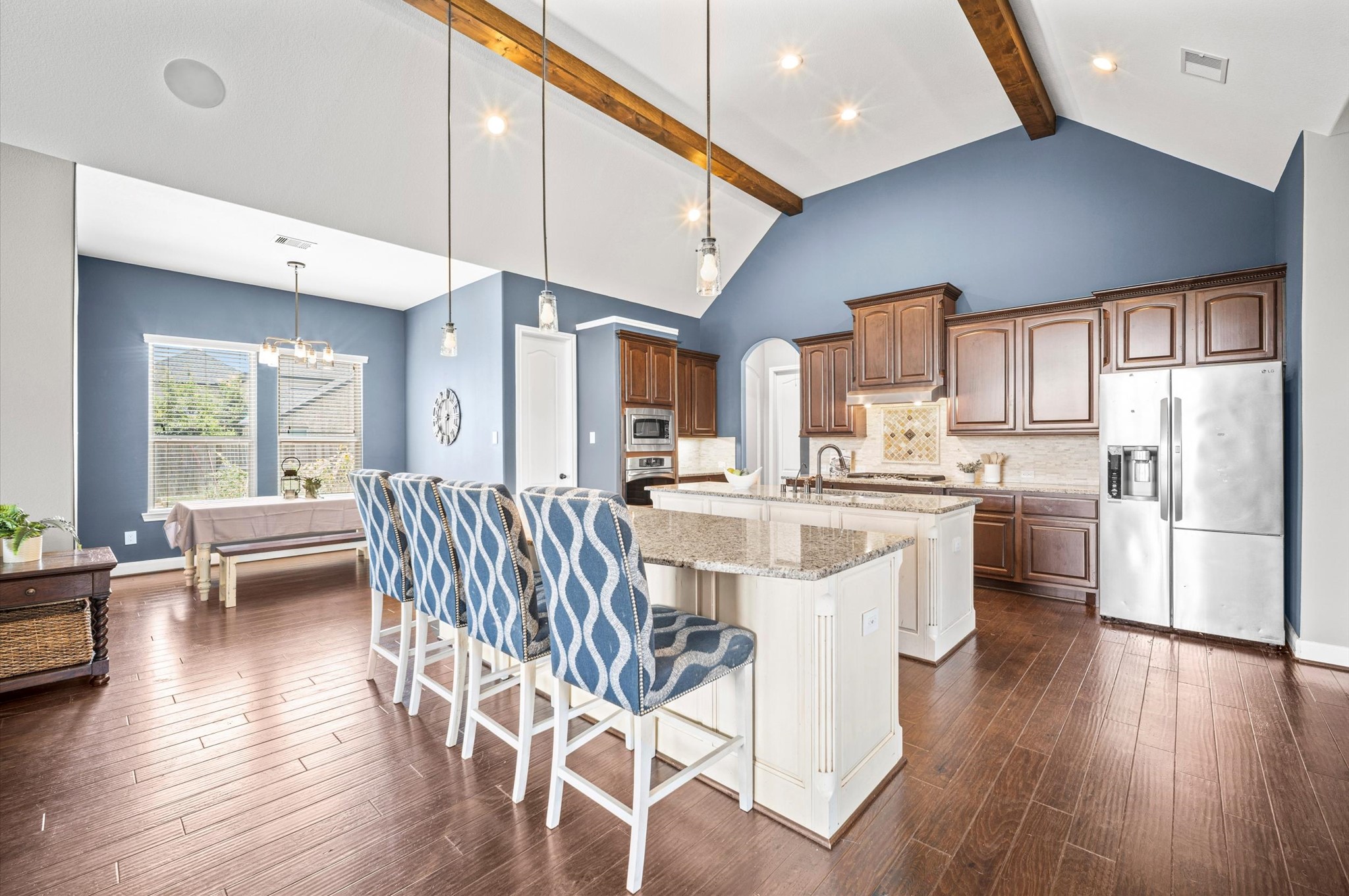 The engineered wood floors run seamlessly throughout the home, joining the gathering spaces together. It's an ideal home for entertaining. Here is your first peek at a chef-worthy kitchen.