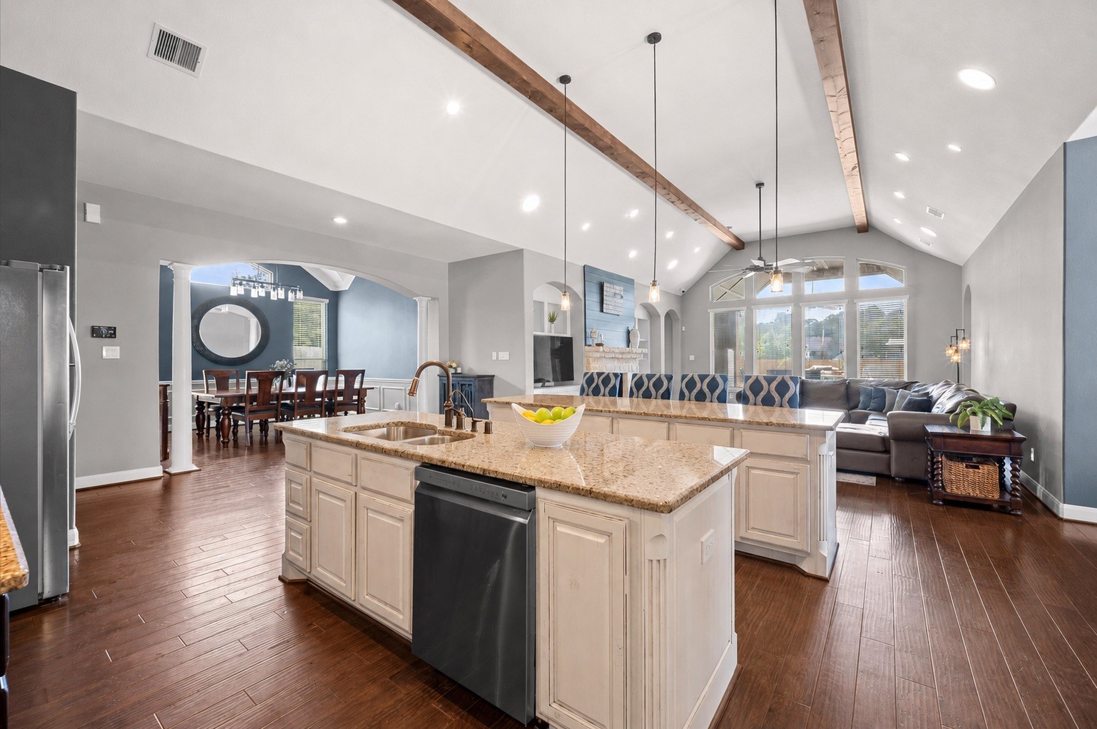 From the kitchen, you have a nice view of the living room and dining room. The exposed beams are an artistic accent that joins these rooms together.