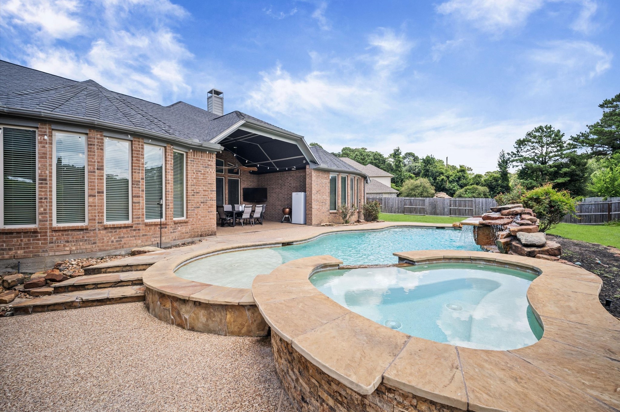 This grand backyard still offers quite a bit of green space on either side of the home, perfect for playtime or pets.