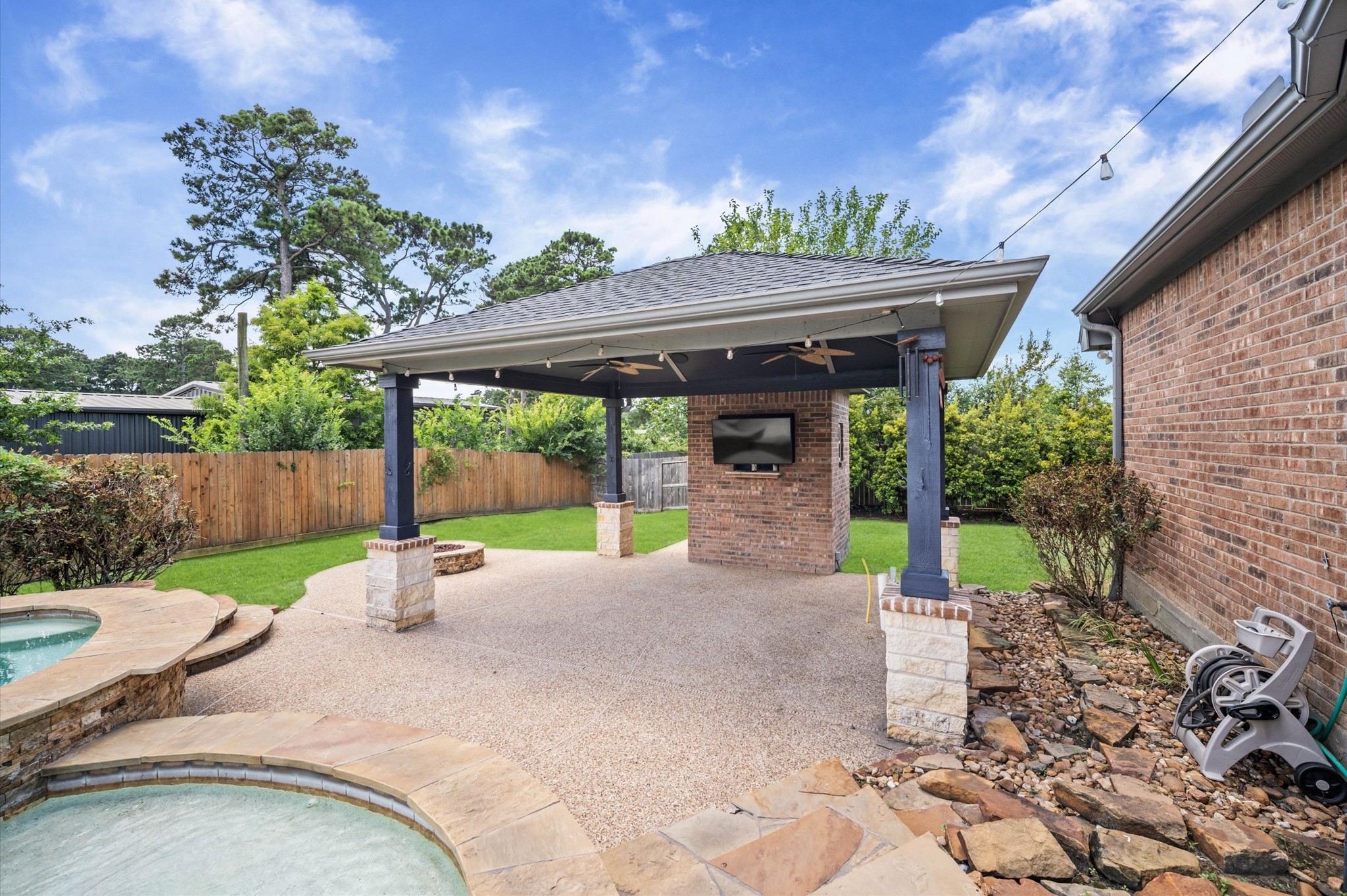 The gazebo is a great place for a collection of lounge chairs or even a future bar. Notice the firepit located on the side.