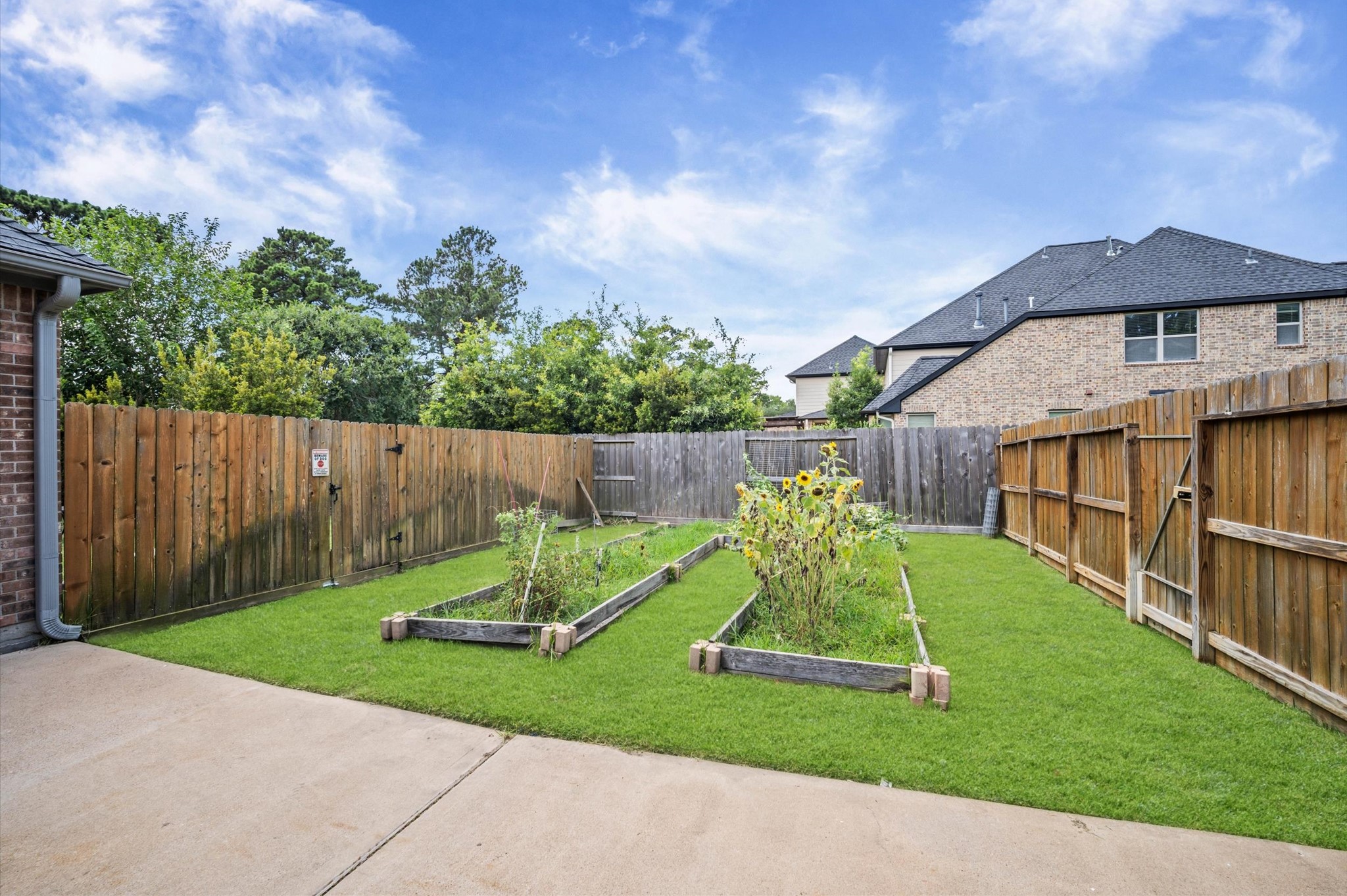 Planter beds located in the side yard are perfect for flowers, shrubs, or transform it into a vegetable garden.