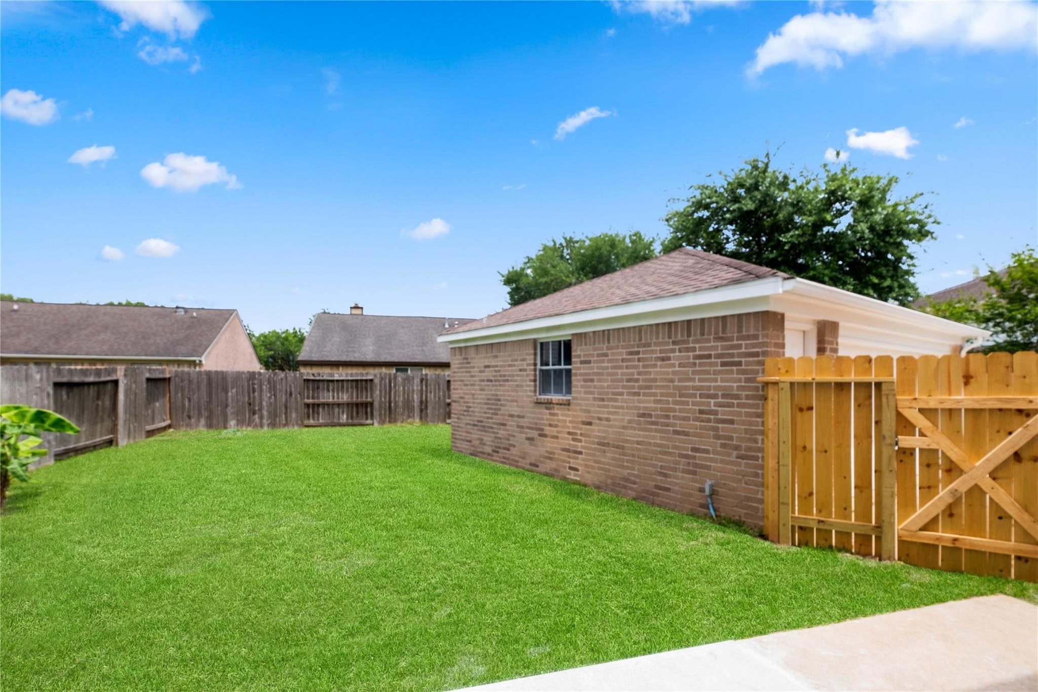 The spacious backyard offers plenty of room for outdoor activities, entertaining, or simply relaxing in your own private outdoor space.
