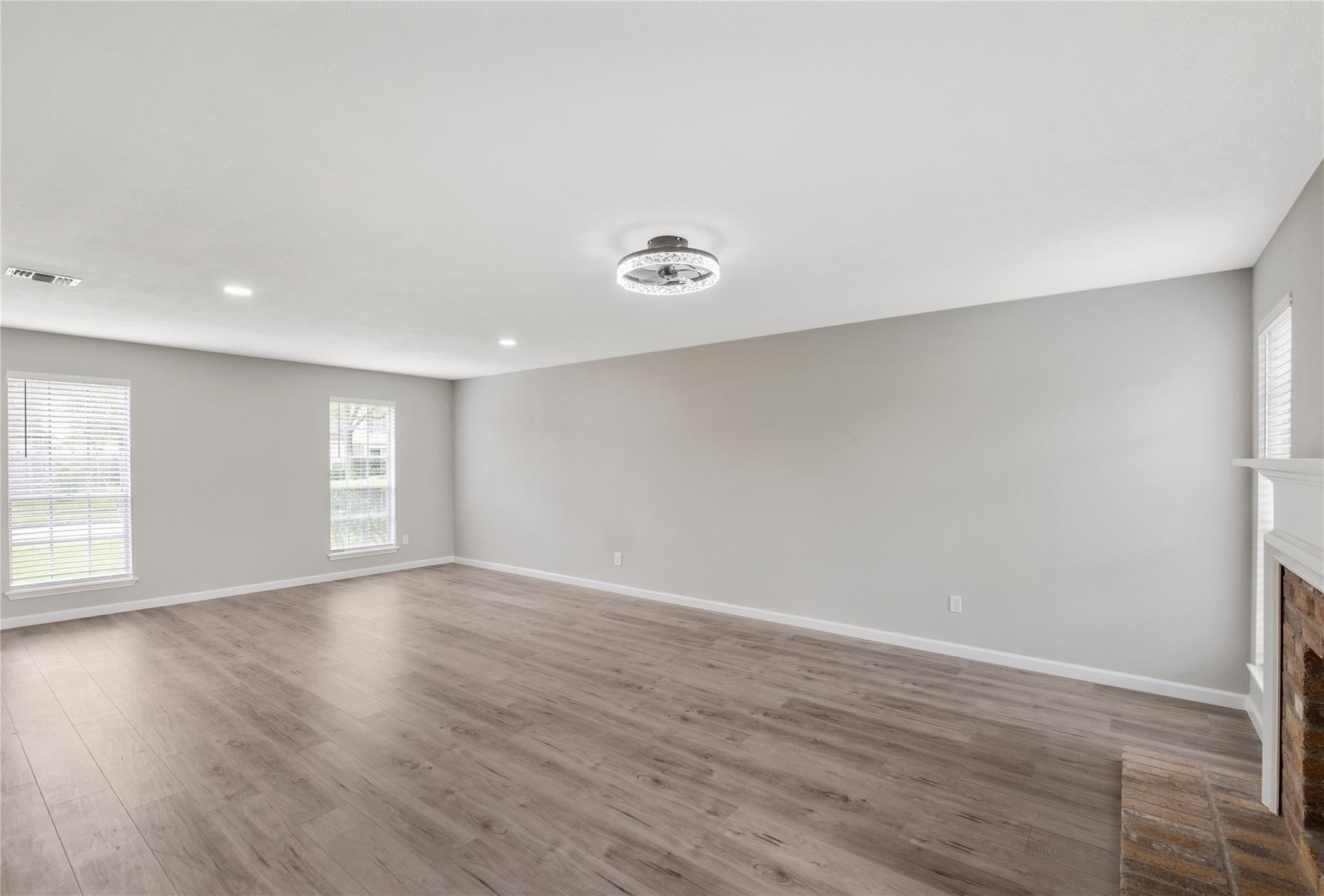 The spacious living area offers plenty of room for gathering and entertaining, with updated flooring and abundant natural light throughout. The spacious living area offers plenty of room for gathering and entertaining, with updated flooring and abundant natural light throughout.