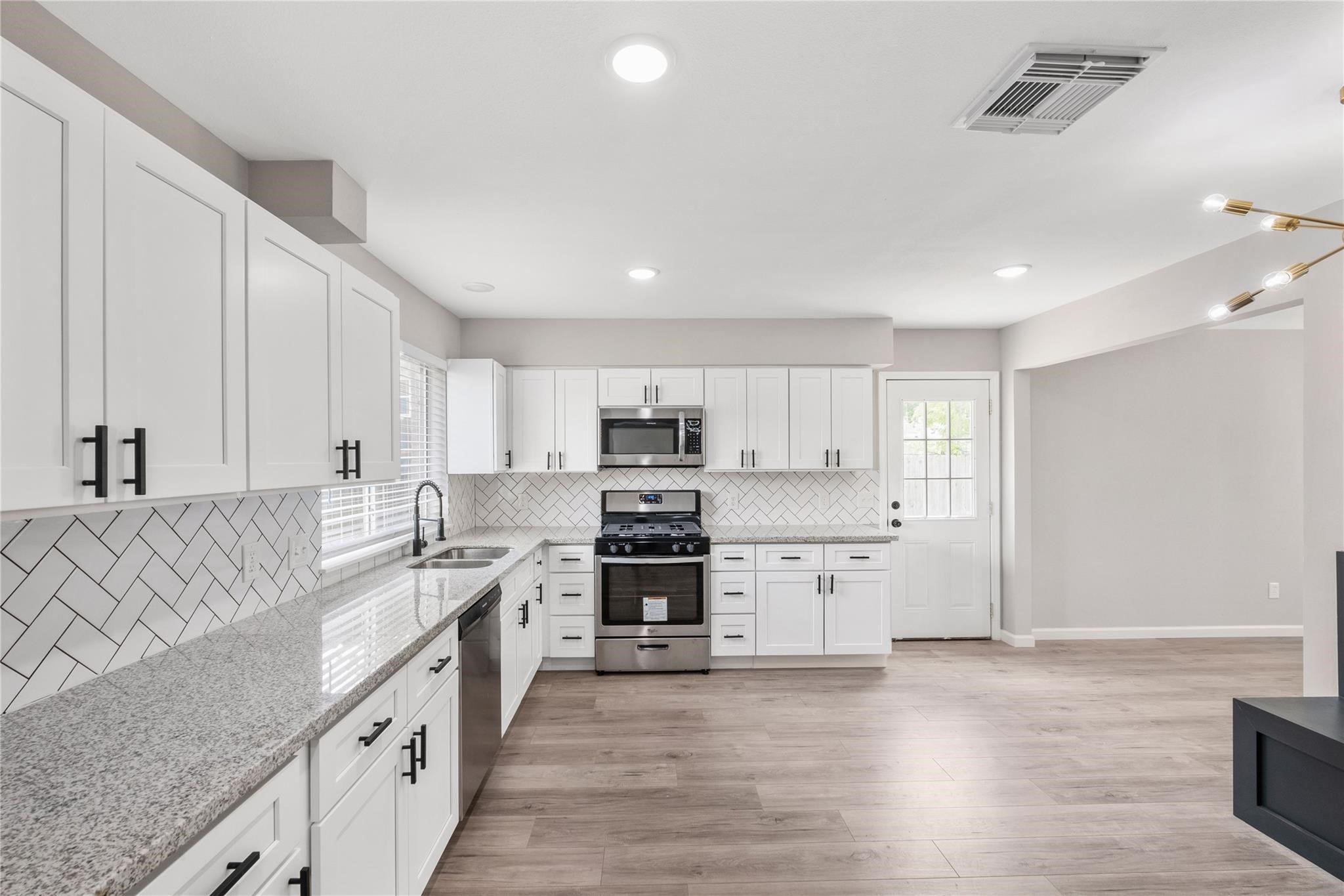 Completely renovated, the kitchen features updated cabinetry, modern finishes, and plenty of counter space. Completely renovated, the kitchen features updated cabinetry, modern finishes, and plenty of counter space.