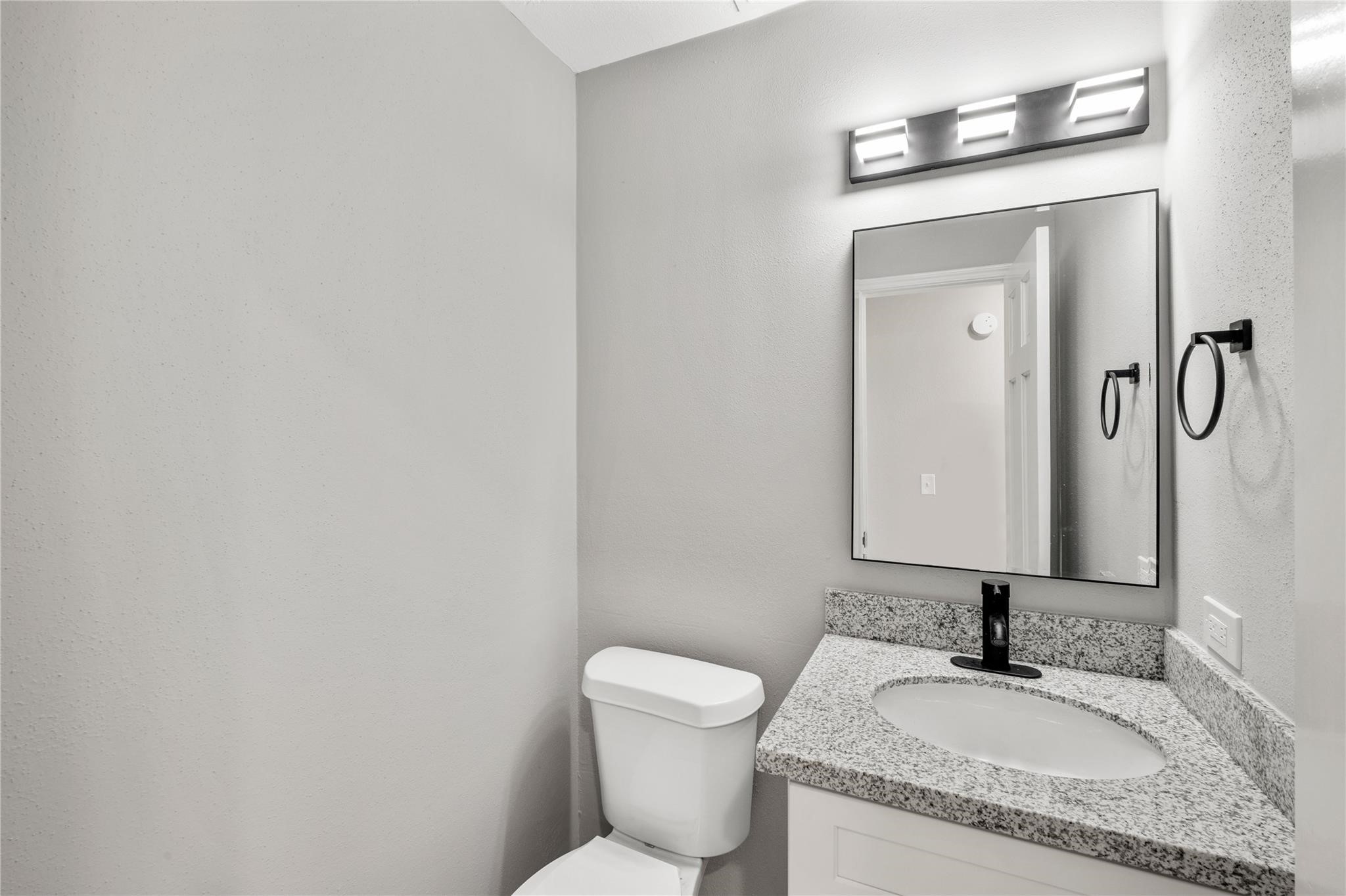 The updated half bath features a granite vanity, modern fixtures, and stylish finishes that complement the home's recent renovations. The updated half bath features a granite vanity, modern fixtures, and stylish finishes that complement the home's recent renovations.