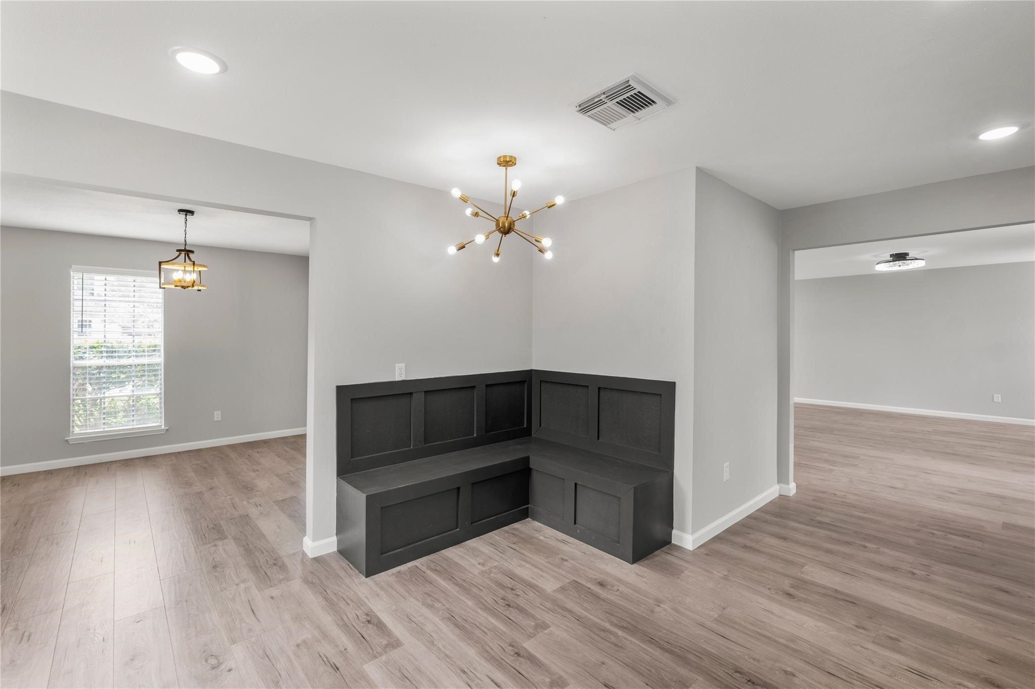 The custom built-in bench creates a unique focal point and adds both style and functionality to the space, with the formal dining room and living area just beyond. The custom built-in bench creates a unique focal point and adds both style and functionality to the space, with the formal dining room and living area just beyond.
