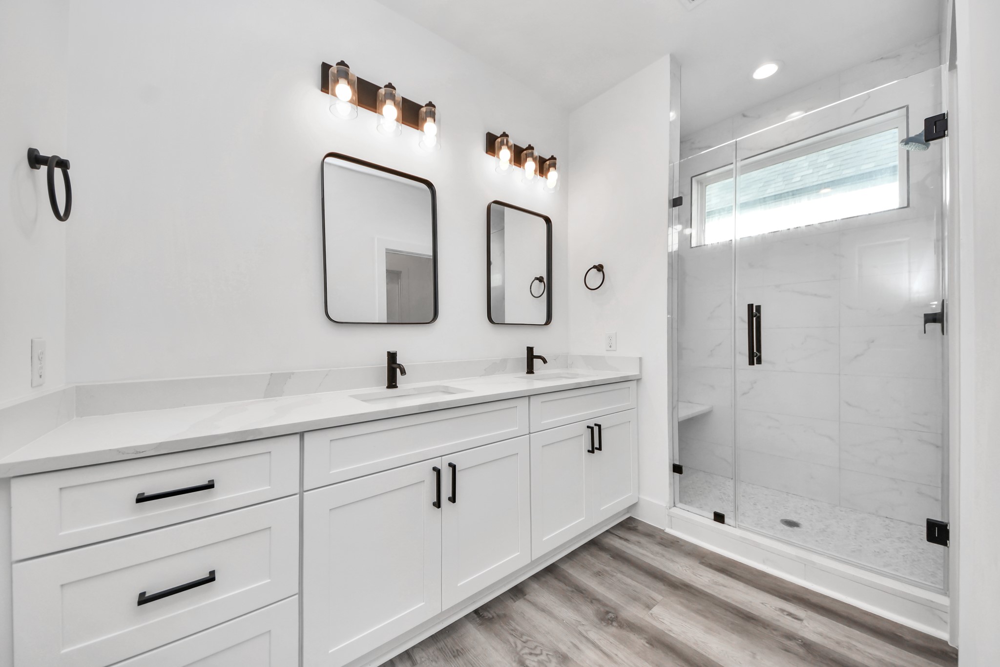 Primary bathroom with dual sinks and walk in shower.