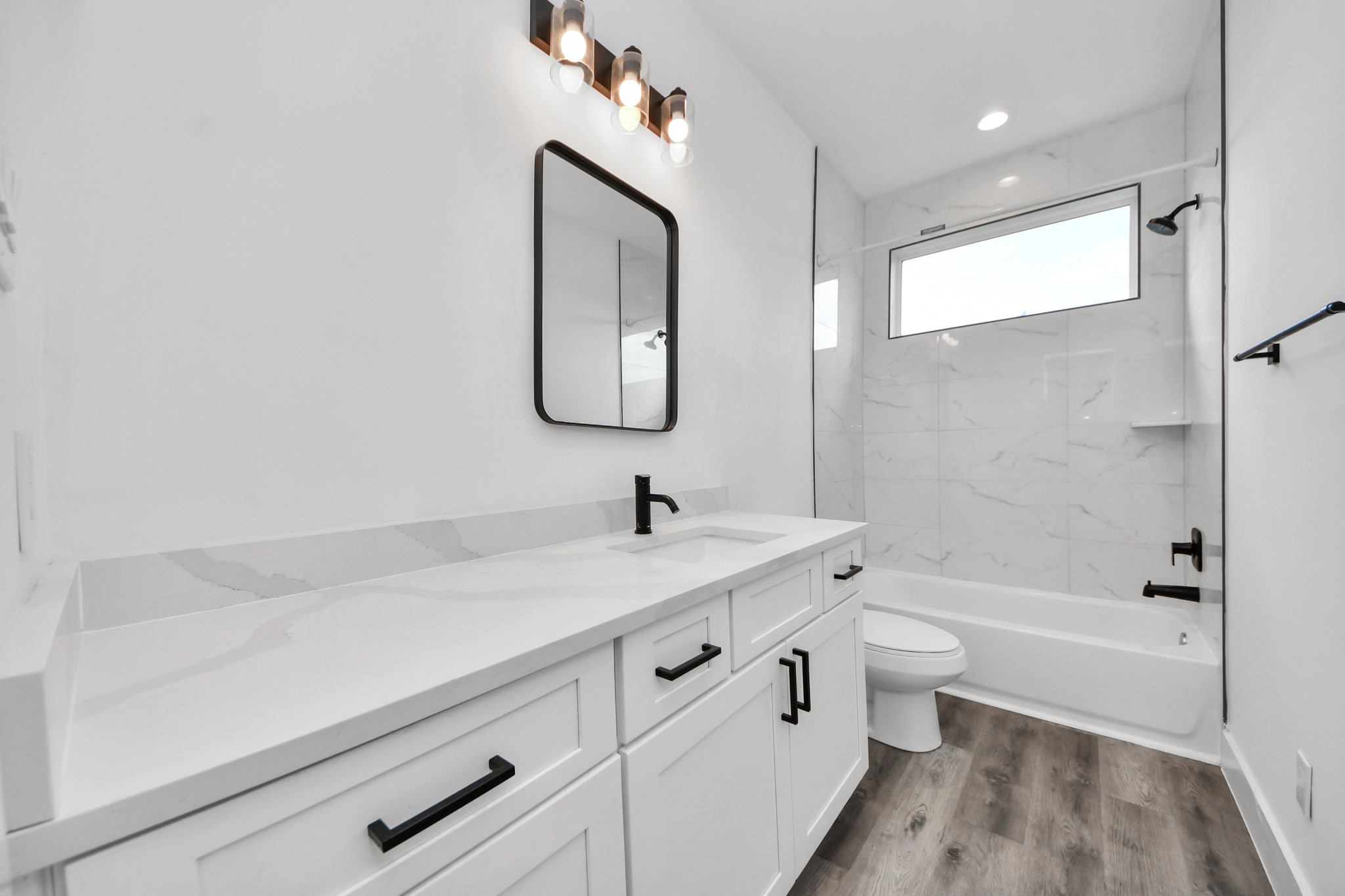 Upstairs full bathroom with plenty of vanity space.