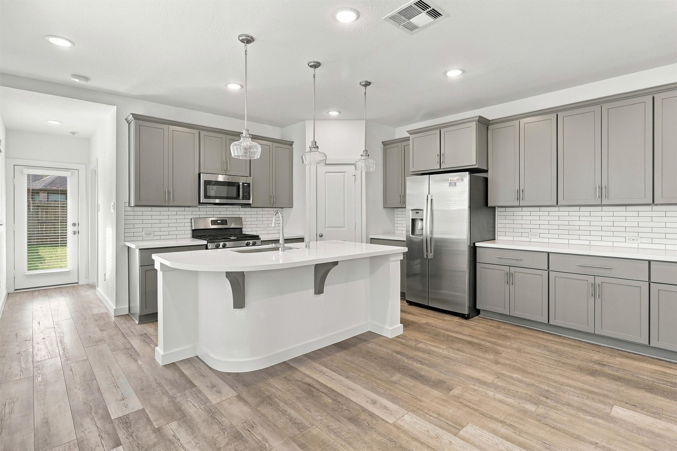 This kitchen has ample cabinetry and storage space, and enough countertop space for all of your kitchen prep needs.