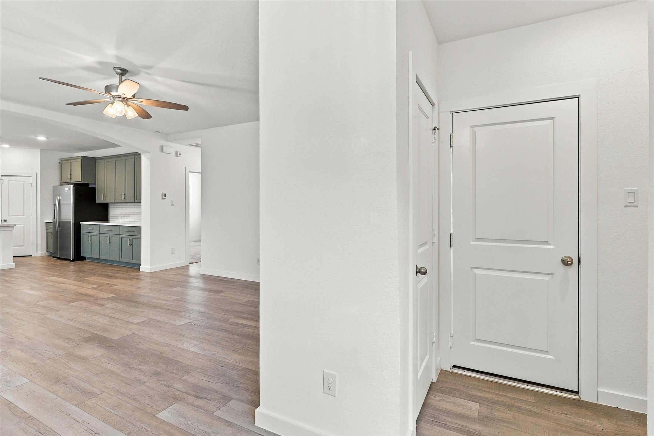 Entry way features storage closet (door to the Left), garage entry, and laundry room (directly to the Right).