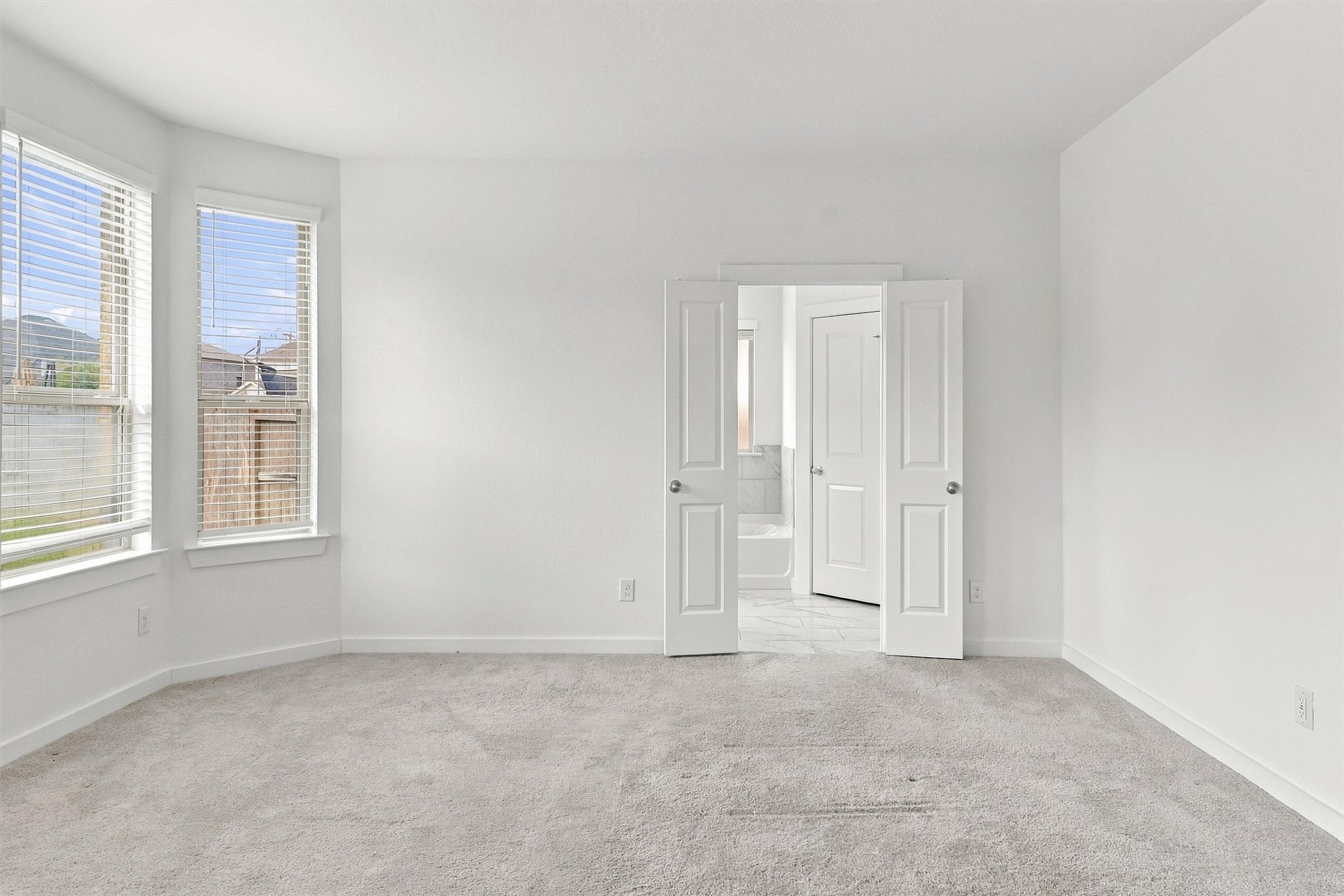 French doors leading to the primary bath.